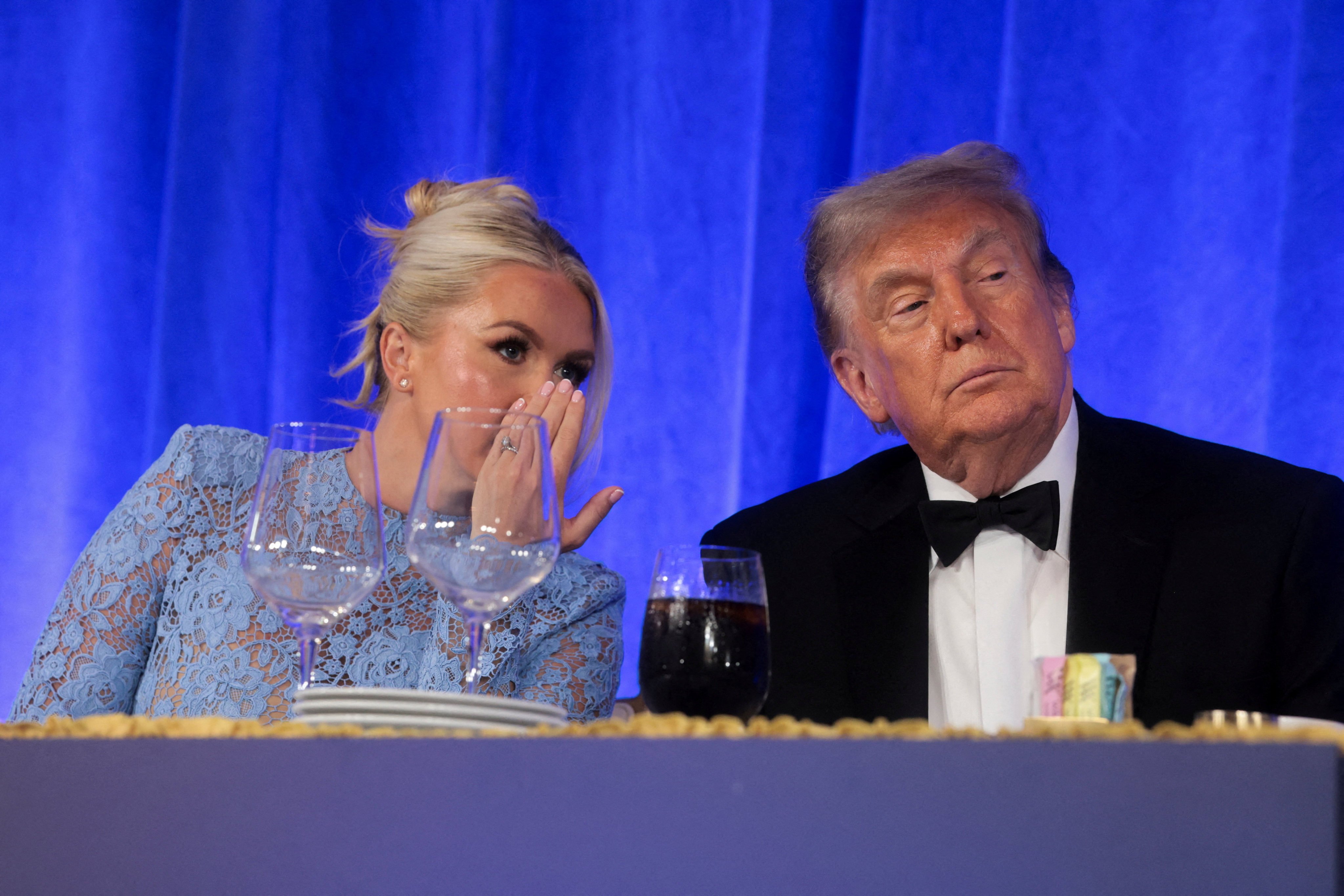 White House press secretary Karoline Leavitt speaks to US President Donald Trump at an event in Washington on July 24. Photo: Reuters