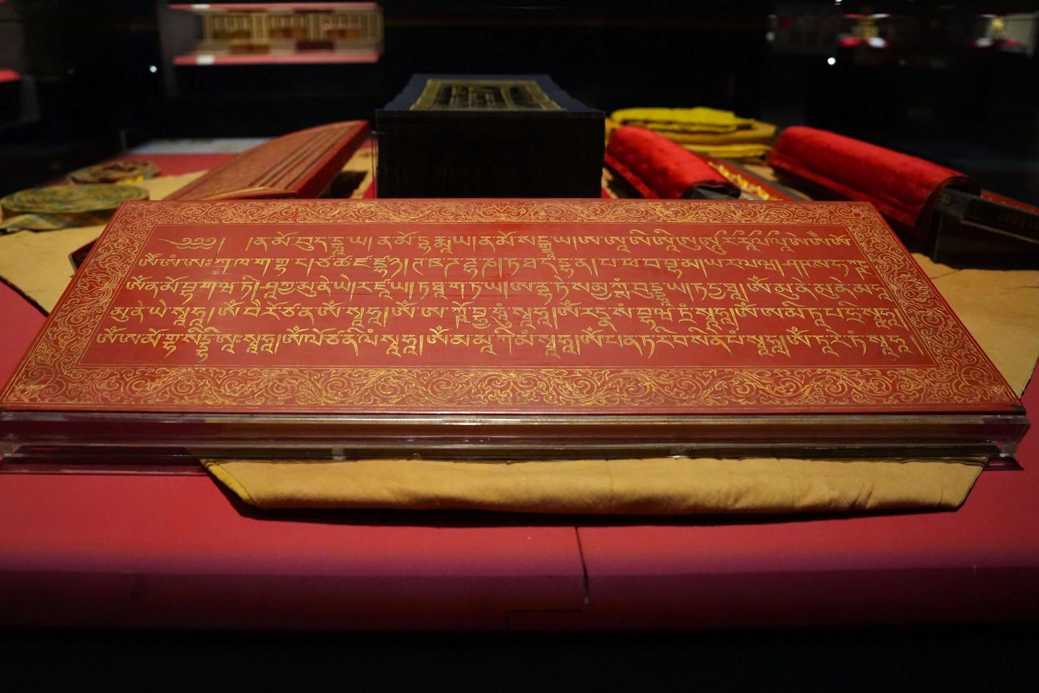 One of the red-lacquered outer protective boards of the Tibetan Dragon Canon. The boards bear inscriptions of Buddhist mantras. Photo: NPM