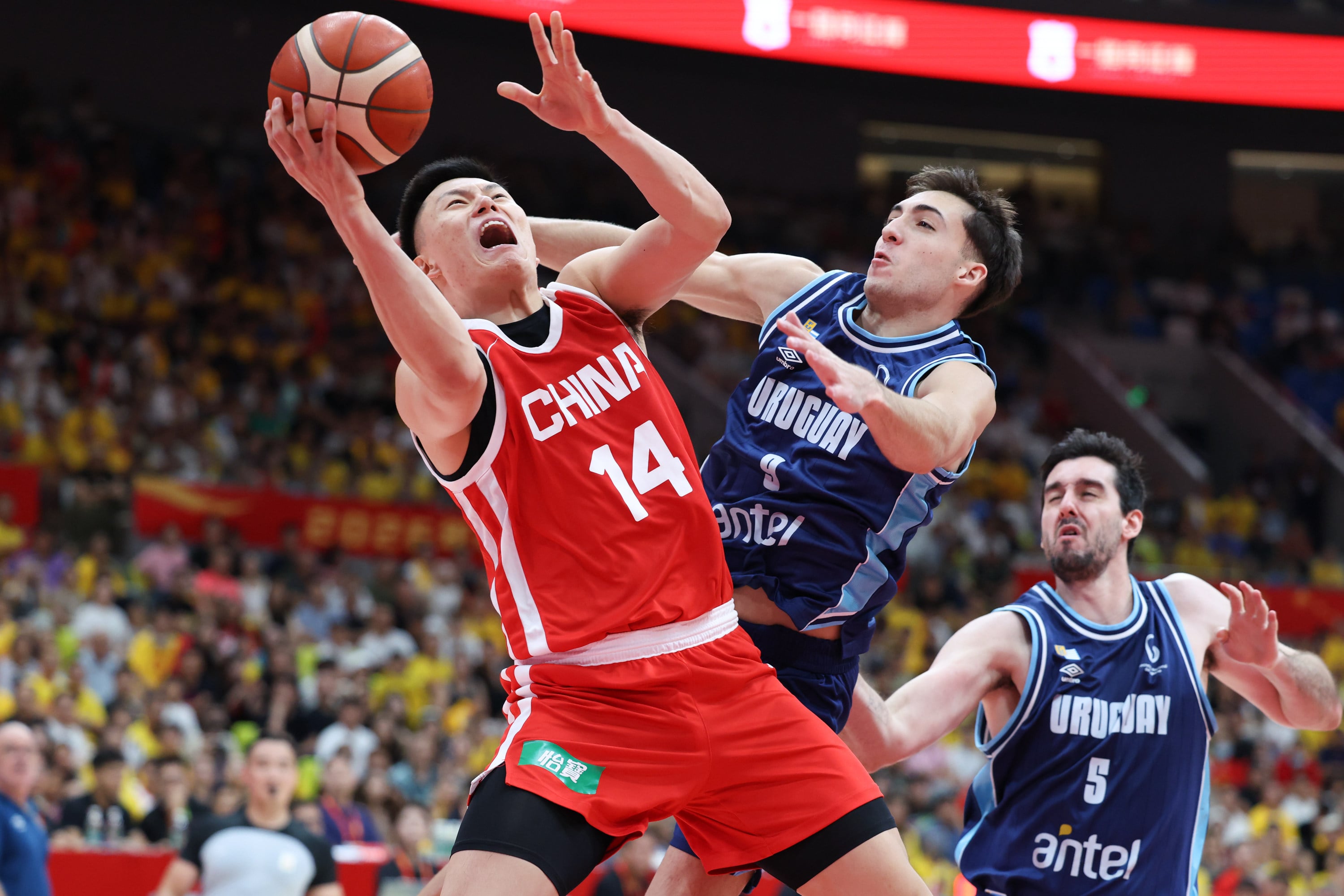 China's Li Hongquan (left) drives for a layup in his team's 19-point loss against Uruguay in Foshan, Guangdong, on Saturday. Photo: Xinhua