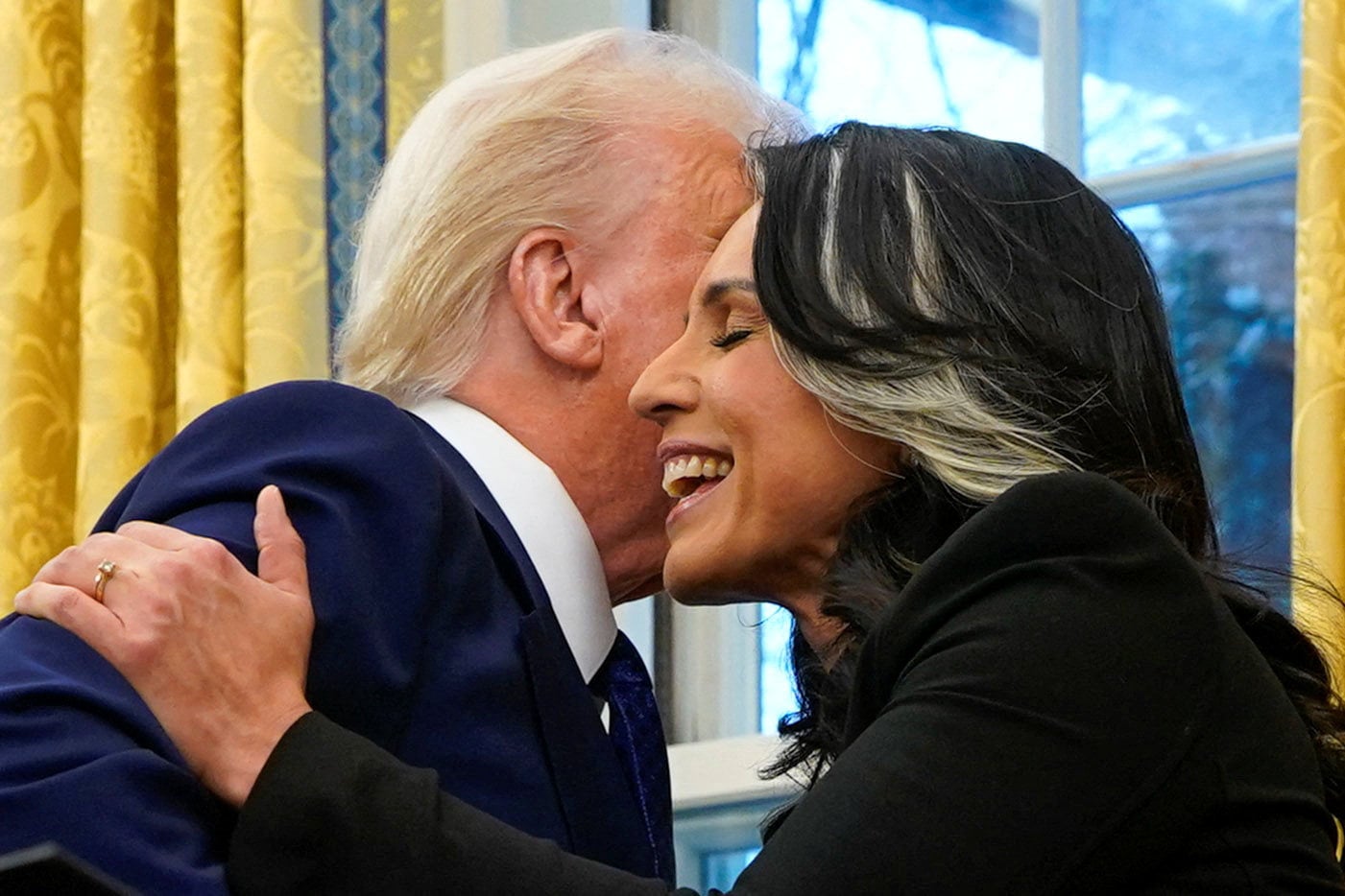 Director of National Intelligence Tulsi Gabbard hugs US President Donald Trump at the White House last year. Photo: Reuters