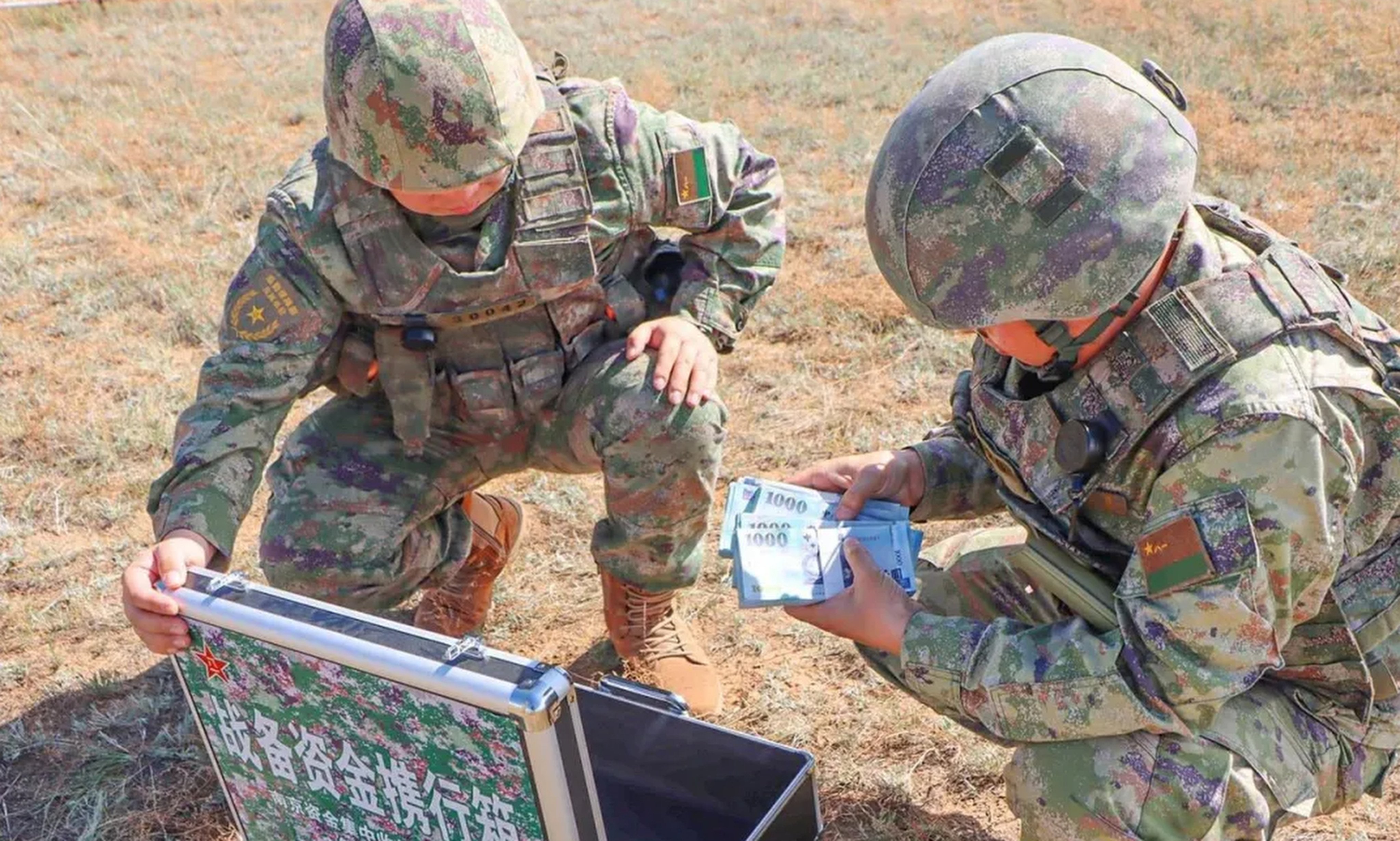 A state newspaper report that has since been deleted included photos of PLA troops counting bundles of New Taiwan dollars delivered by drone during a drill. Photo: qq.com