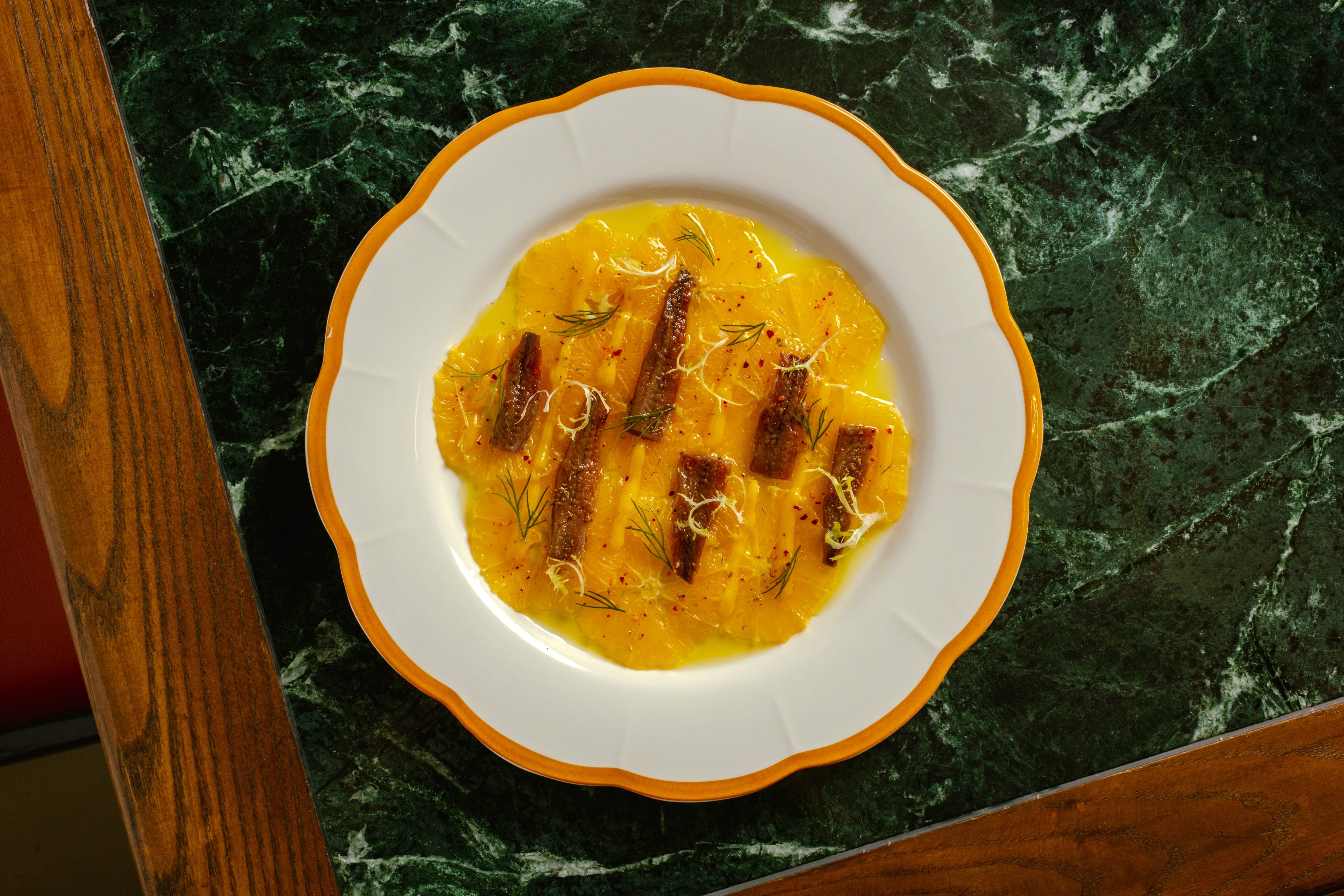 Ninetta’s orange carpaccio combines fruit with fish, vinegar with citrus and chilli with dill. Photo: Nicholas Wong