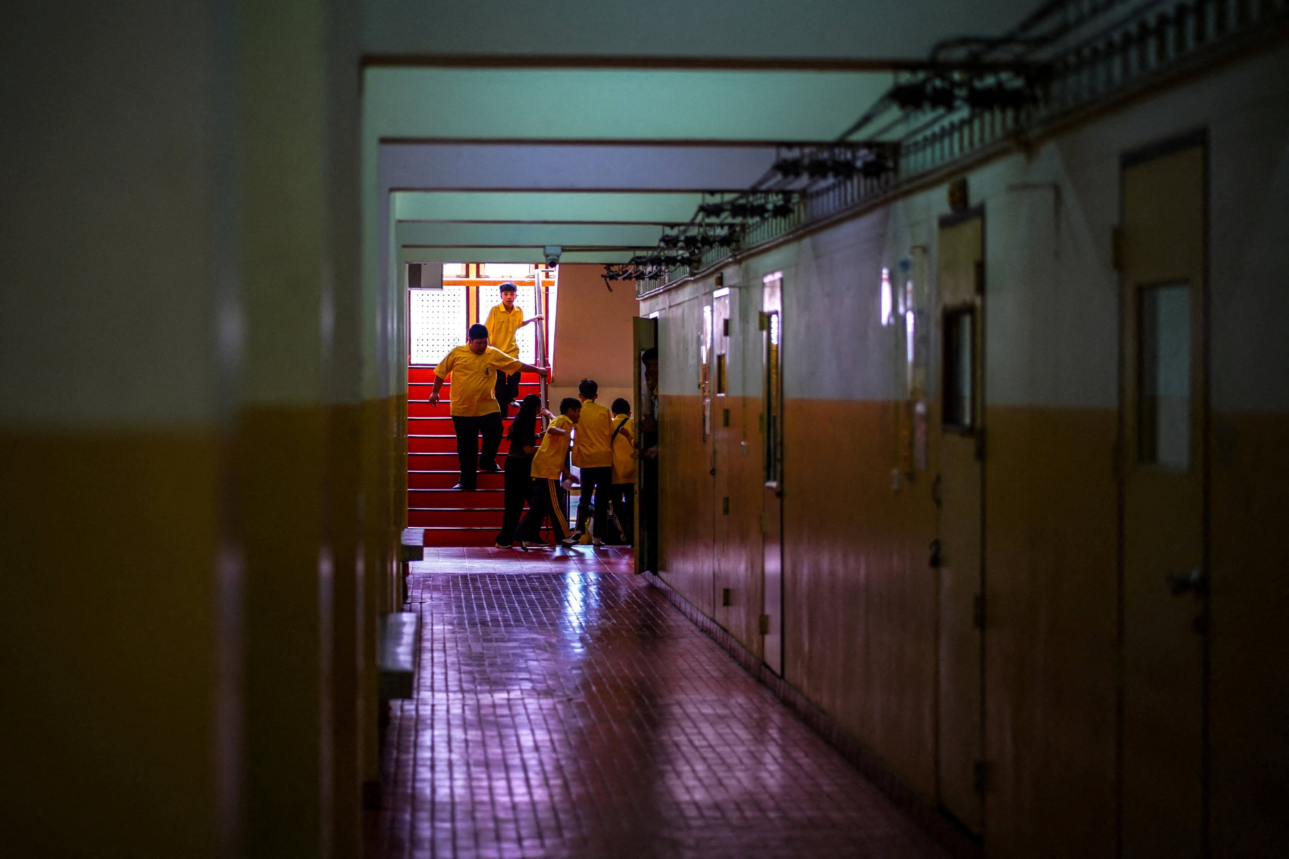 Students run to hide during a drill by police officers to prepare for an active shooter scenario, at Surasamontree School in Bangkok, Thailand, on Wednesday. Photo: Reuters