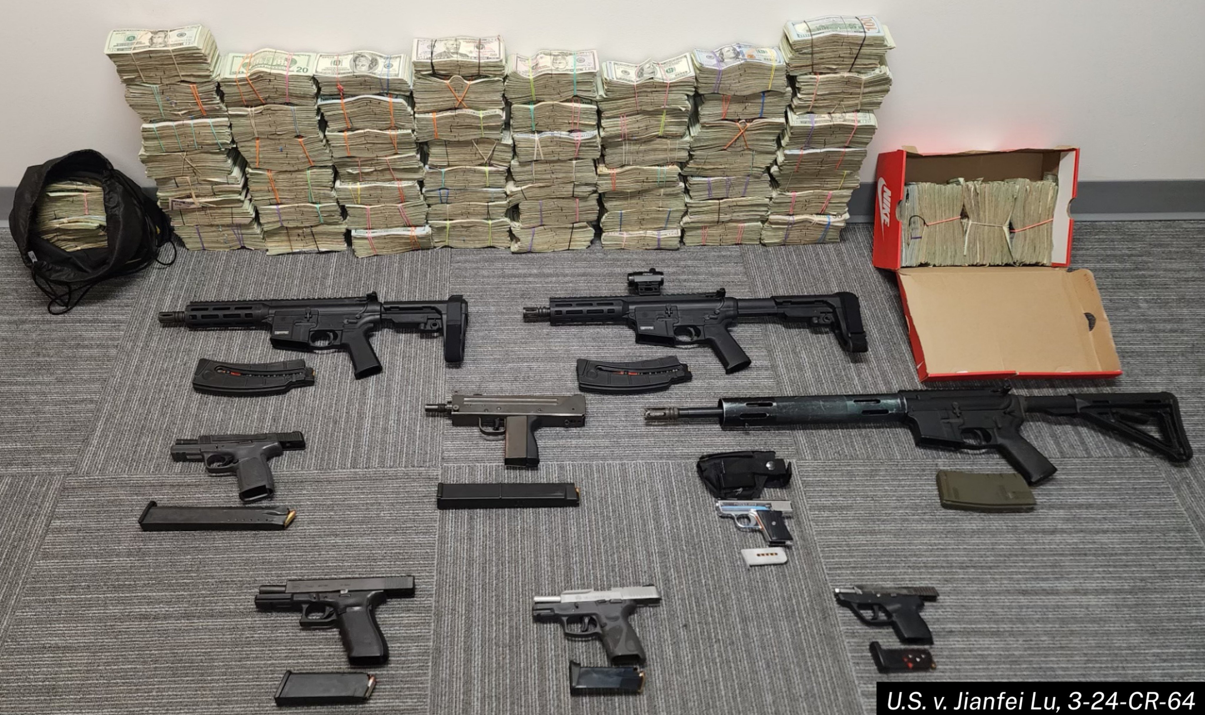 Cash and firearms seized from a criminal organisation that used the services provided by the Chinese money laundering operation, according to prosecutors. Photo: US Department of Justice
