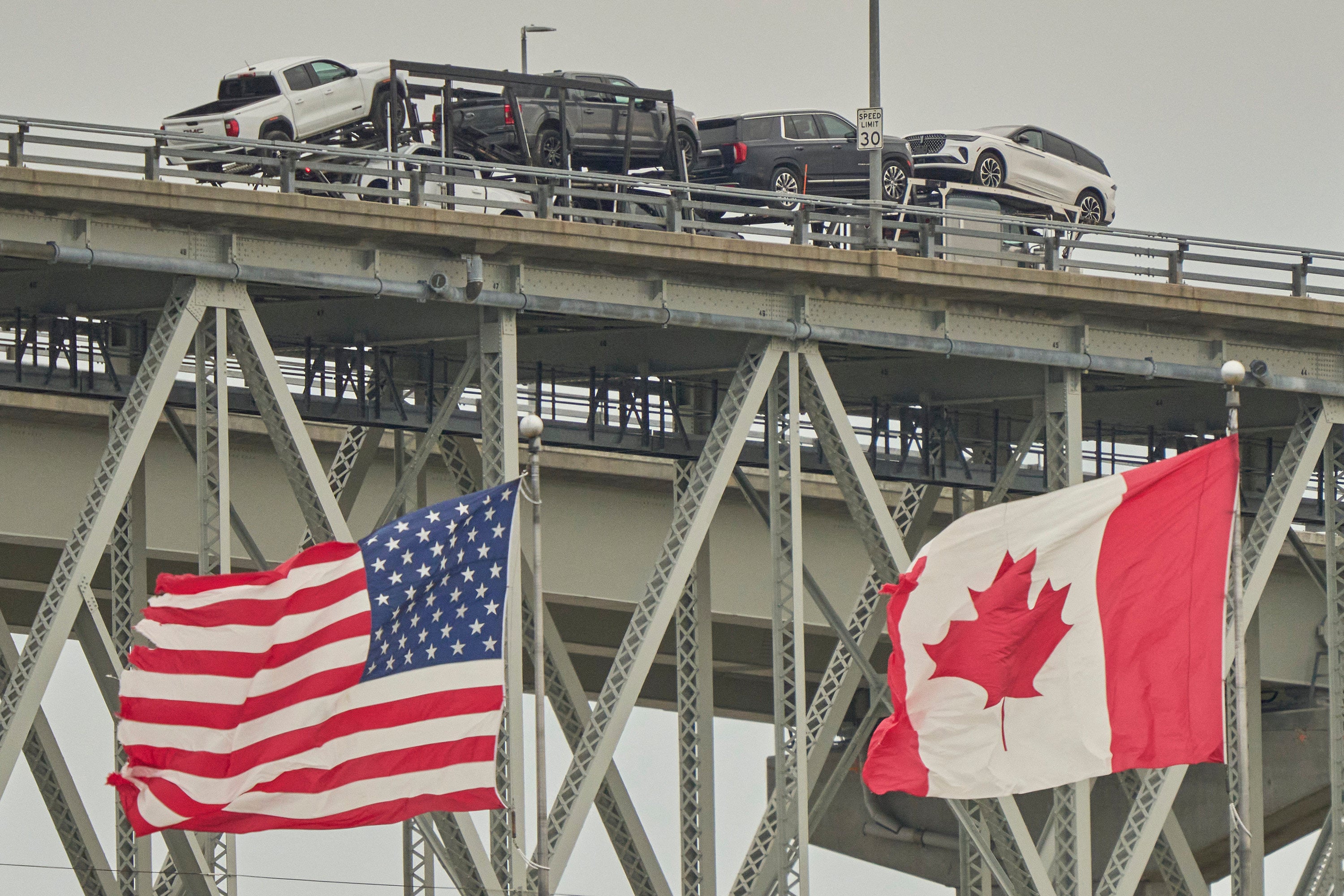 A truck with vehicles crosses the Blue Water Bridge border from Ontario, Canada, into the US in April 2025. Photo: TNS