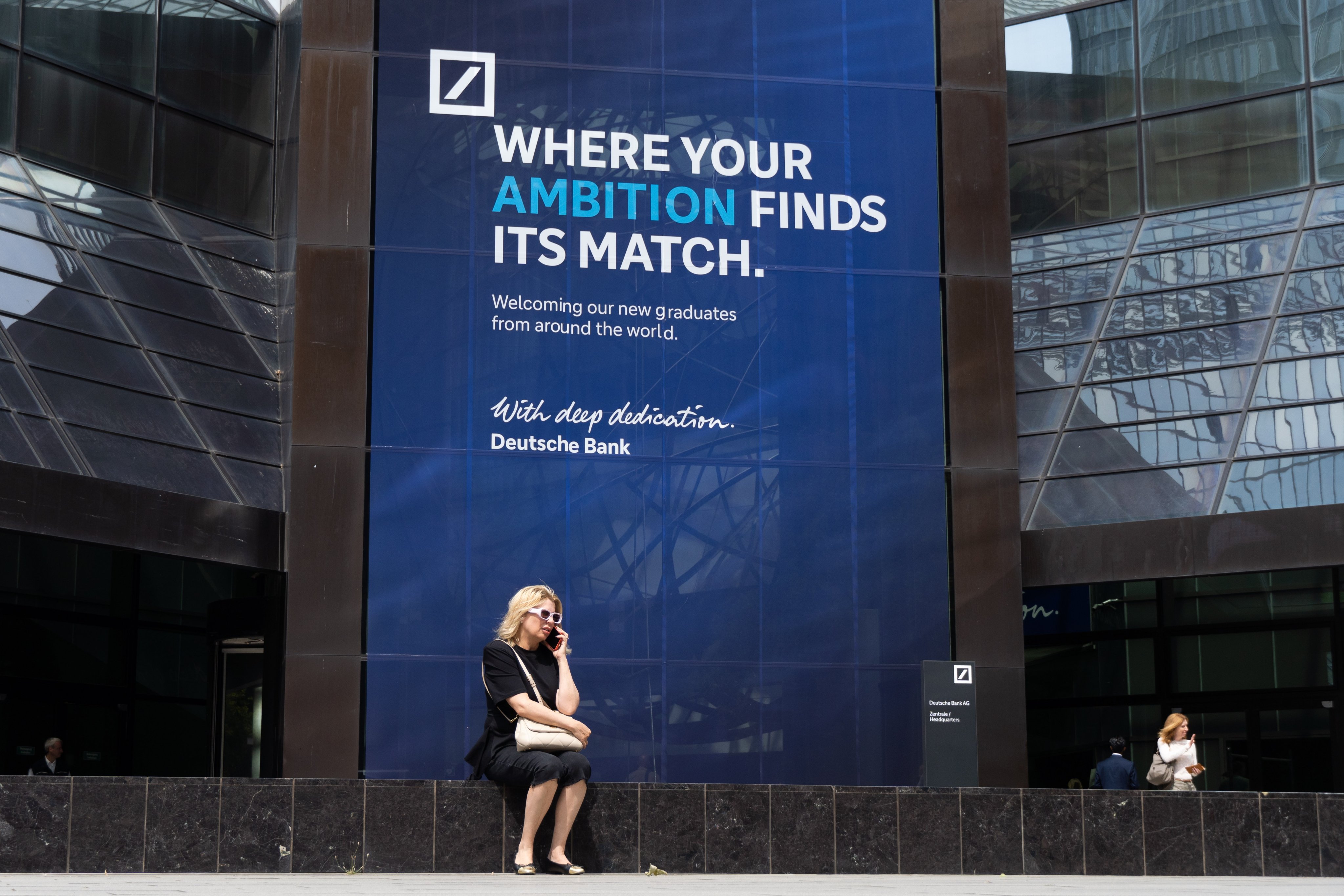 A woman sits in front of the Deutsche Bank central headquarters in Frankfurt on July 22. The People’s Bank of China has authorised Deutsche Bank to serve as a renminbi clearing bank, making it the first European lender to receive such approval. Photo: EPA