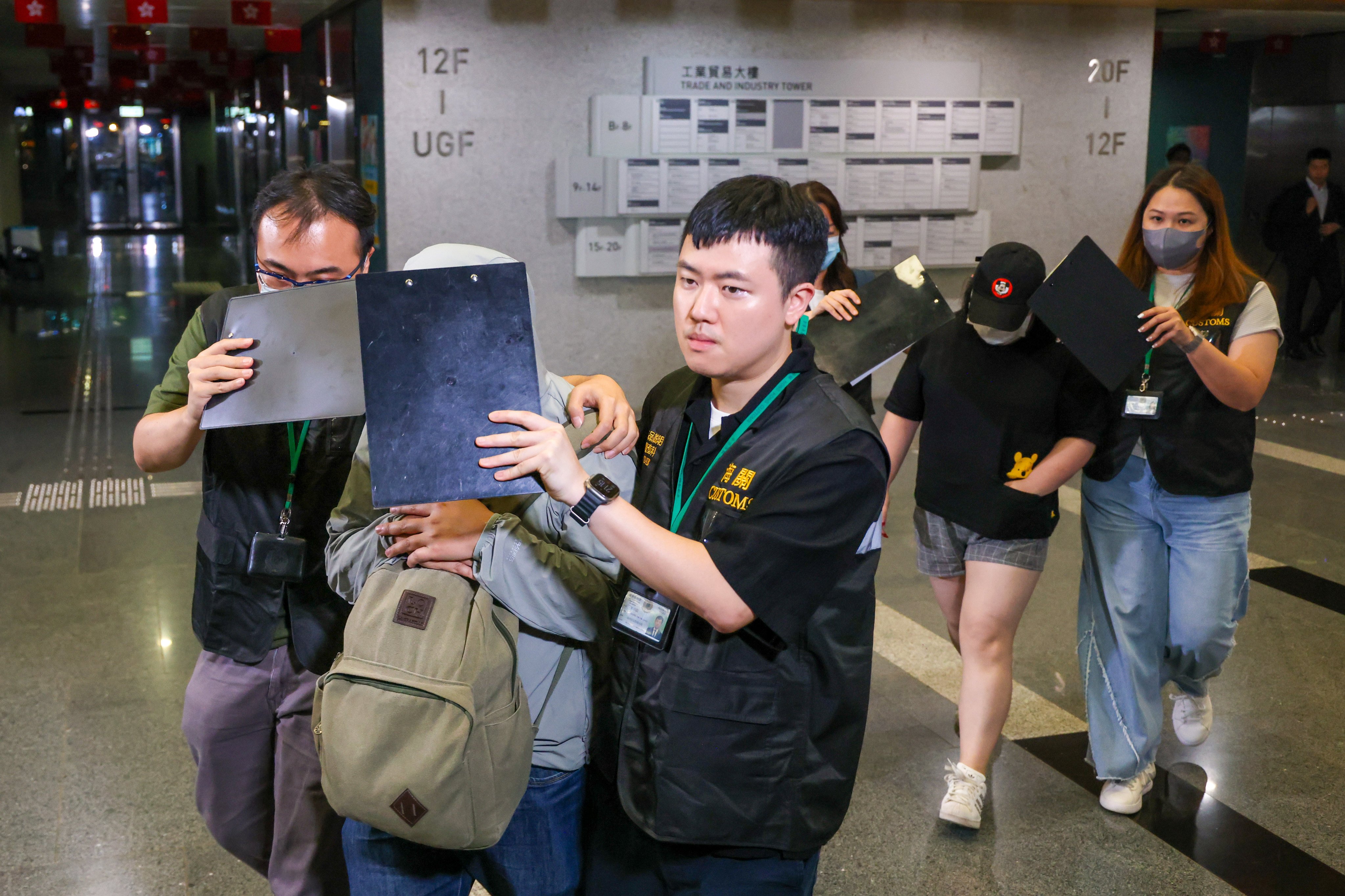 Customs officers take away the two suspects on Wednesday. Photo: Nora Tam