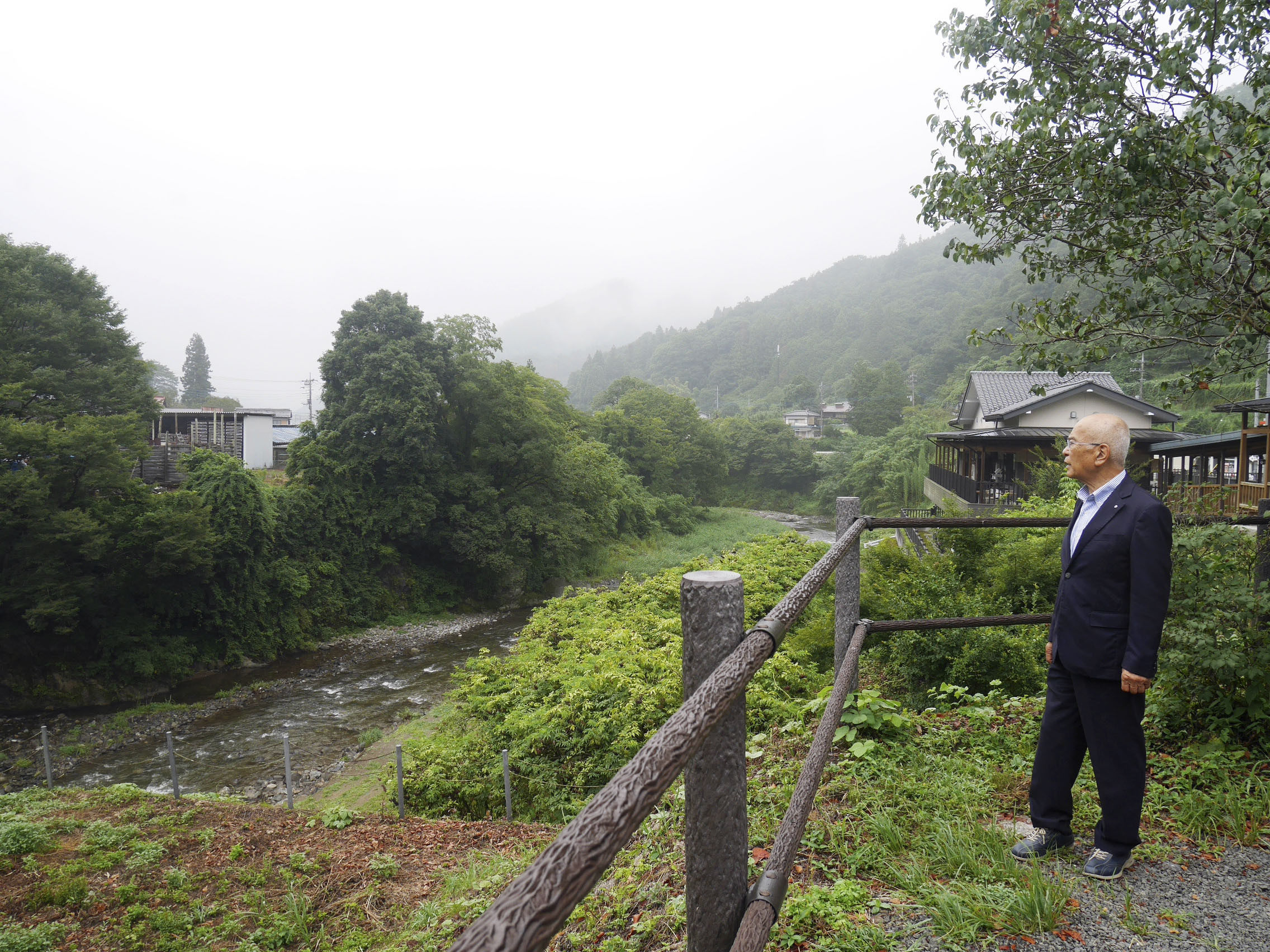 Saijo Hasegawa, mayor of Nanmoku, looks at a river near a roadside station in the Gunma prefecture village on August 3. Photo: Kyodo