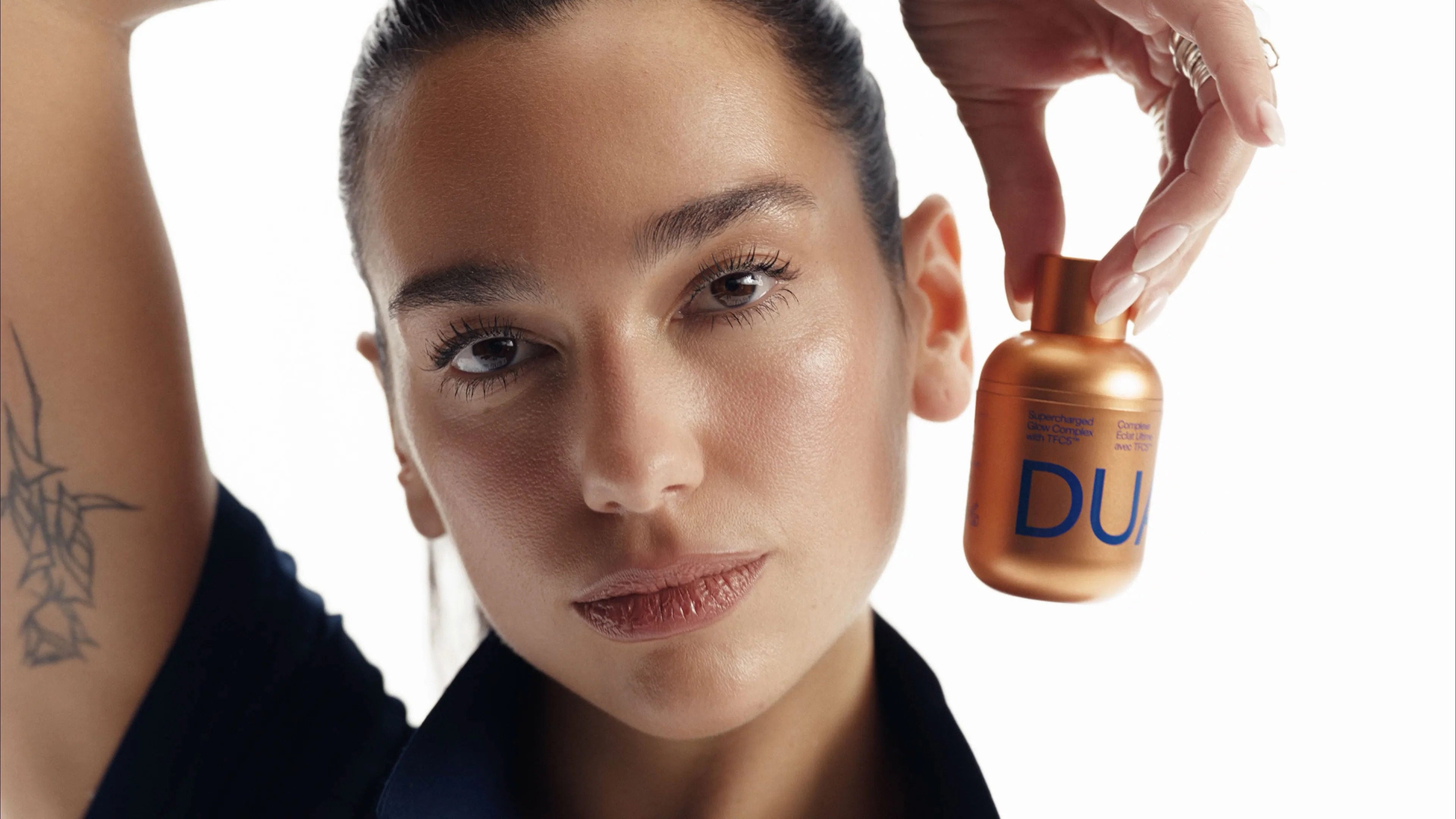 Dua Lipa with the Supercharged Glow Complex, a brightening serum from her Dua by Augustinus Bader skincare line. Photo: Handout