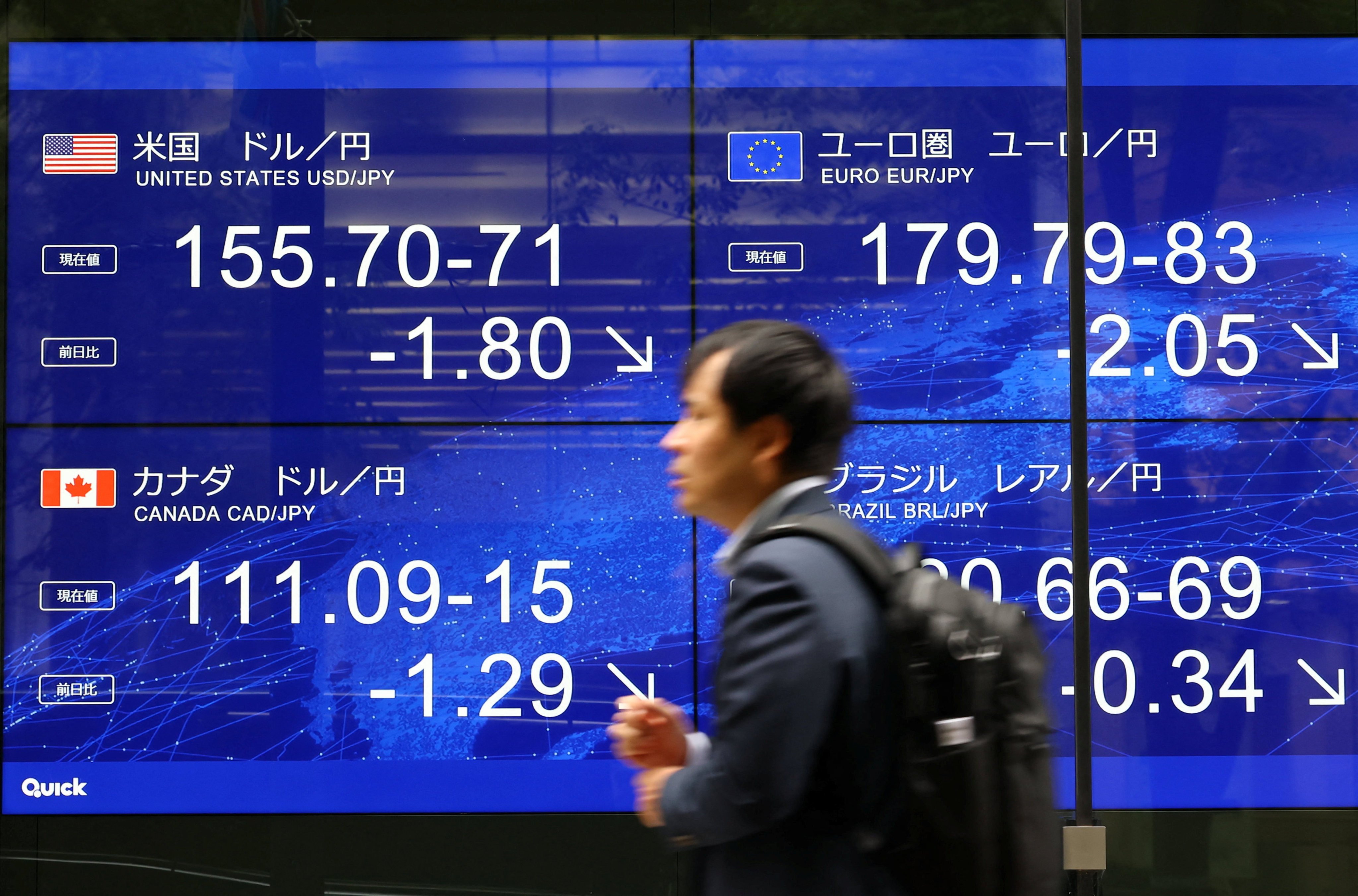 A man walks past an electronic screen displaying the current Japanese yen exchange rate on August 3, after a rare joint US-Japan intervention to prop up the currency. Photo: Reuters