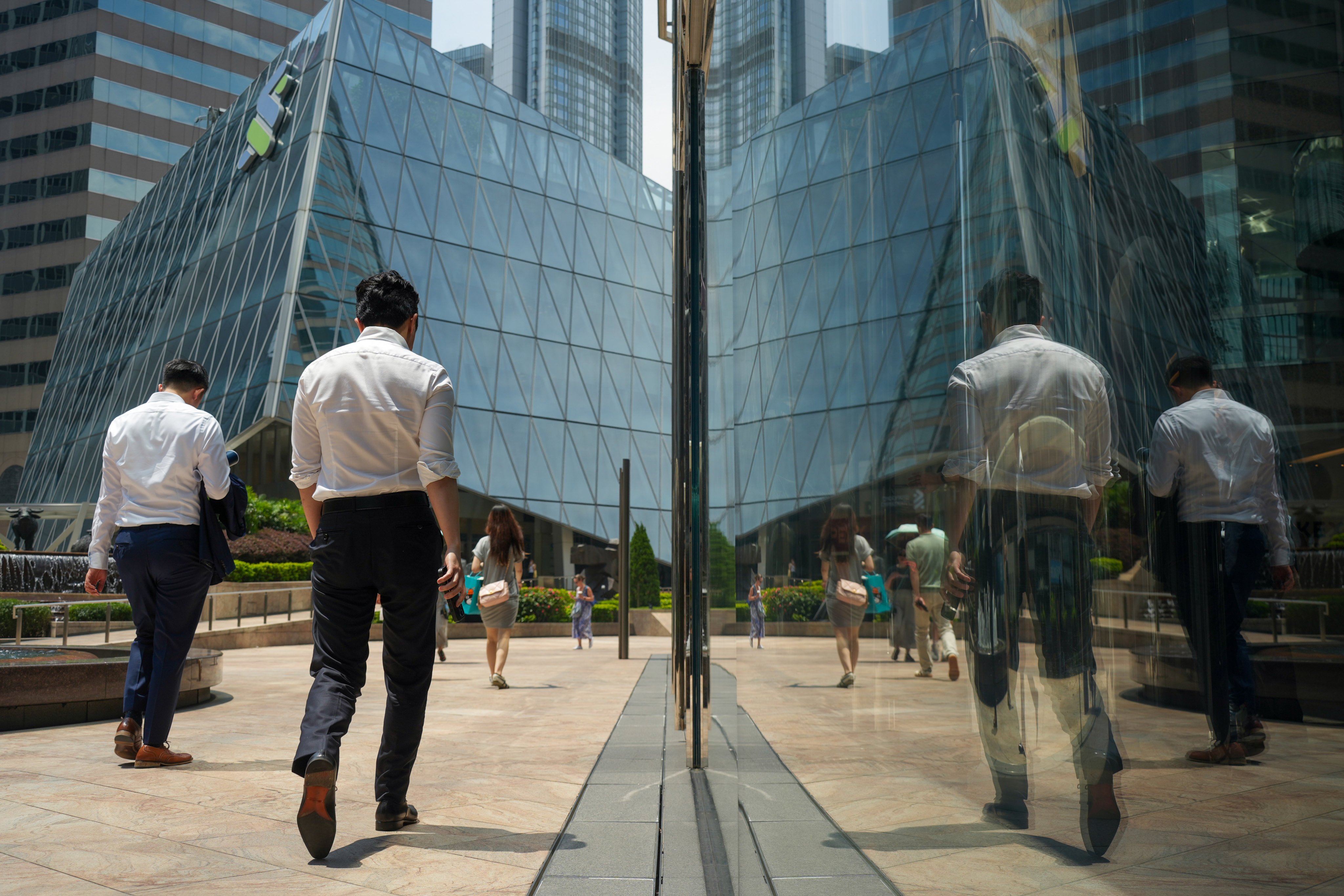 People walk past buildings in Central, Hong Kong. Photo: Sun Yeung