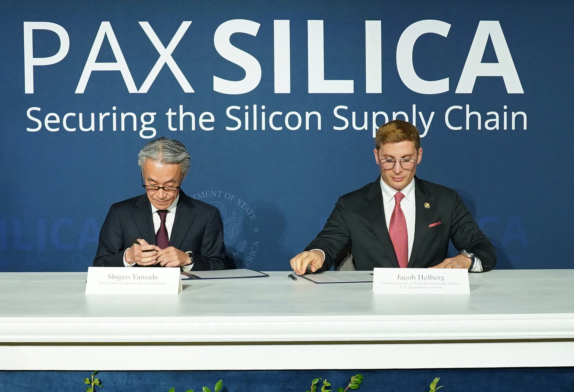 Japanese ambassador to the US Shigeo Yamada and undersecretary of state for economic affairs Jacob Helberg sign the Pax Silica Declaration in Washington in December 2025. Photo: Getty Images via AFP Japanese ambassador to the US Shigeo Yamada and undersecretary of state for economic affairs Jacob Helberg sign the Pax Silica Declaration in Washington in December 2025. Photo: Getty Images via AFP