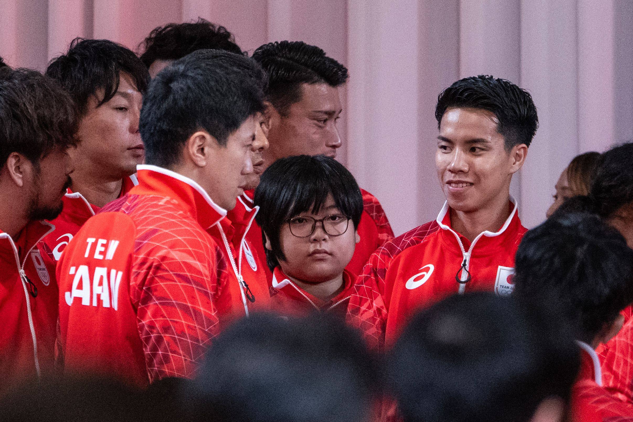 Yuki Kurihara (centre) waits for a Team Japan photo after a ceremony for the Asian Games. Photo: AFP