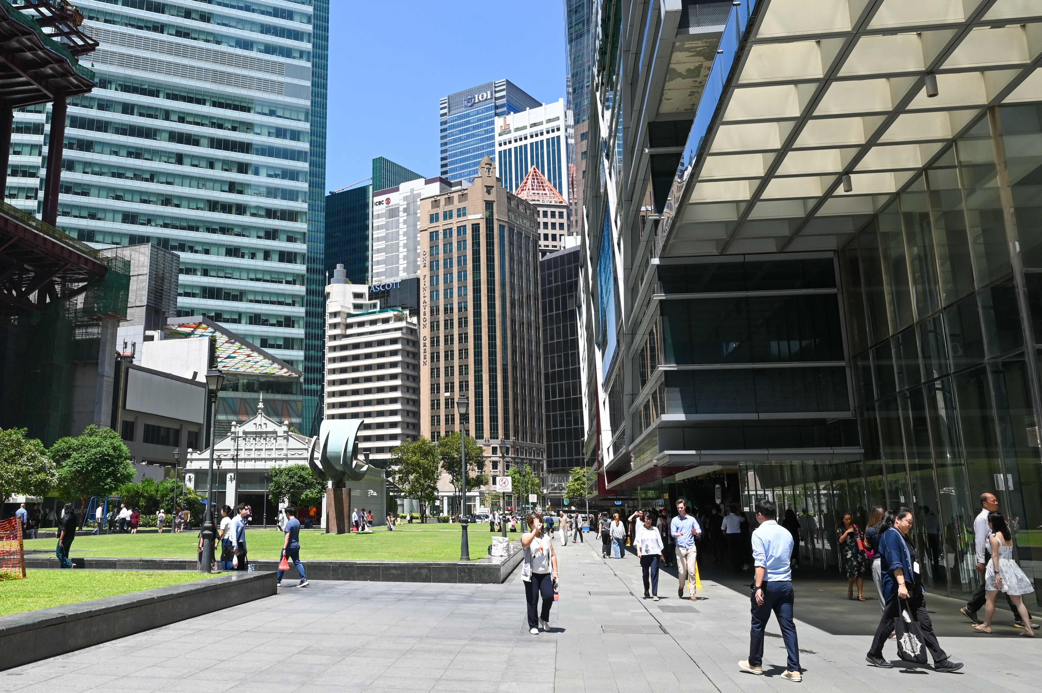 People walk at the financial business district of Raffles Place in Singapore. Photo: AFP