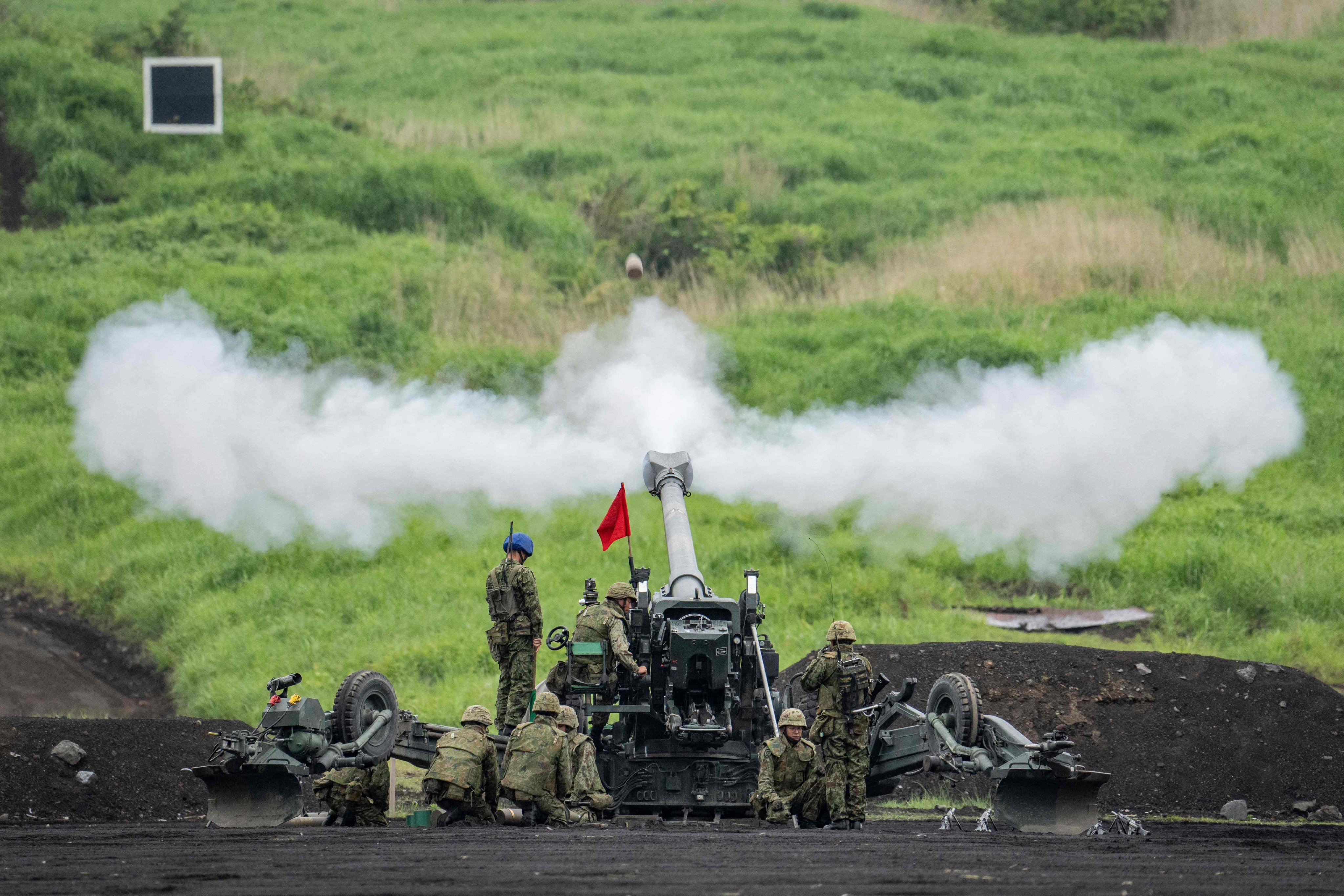 Japan Ground Self-Defence Force soldiers fire a howitzer during a live fire exercise in Gotemba in June. Photo: AFP