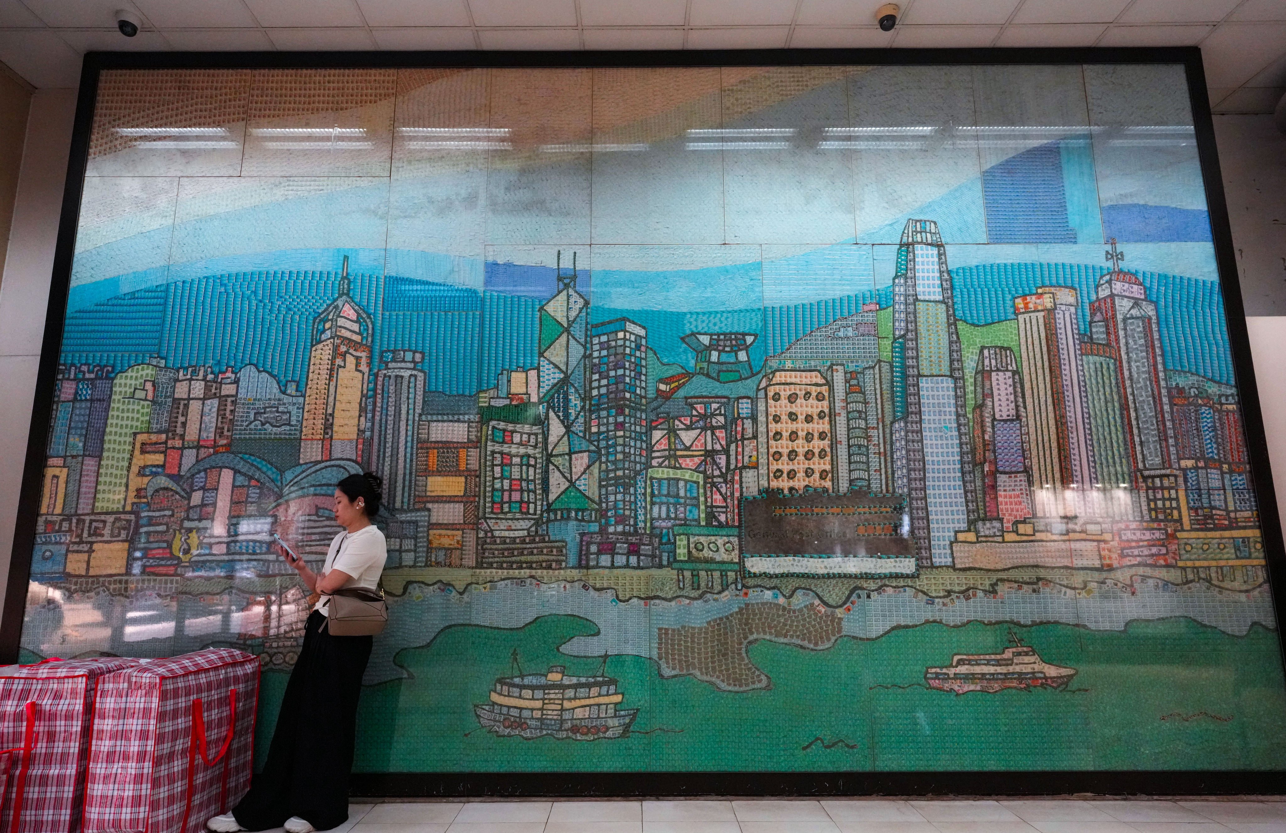 A woman waits at the General Post Office in Central, Hong Kong. Hongkong Post has recorded a loss for eight consecutive years. Photo: Jelly Tse