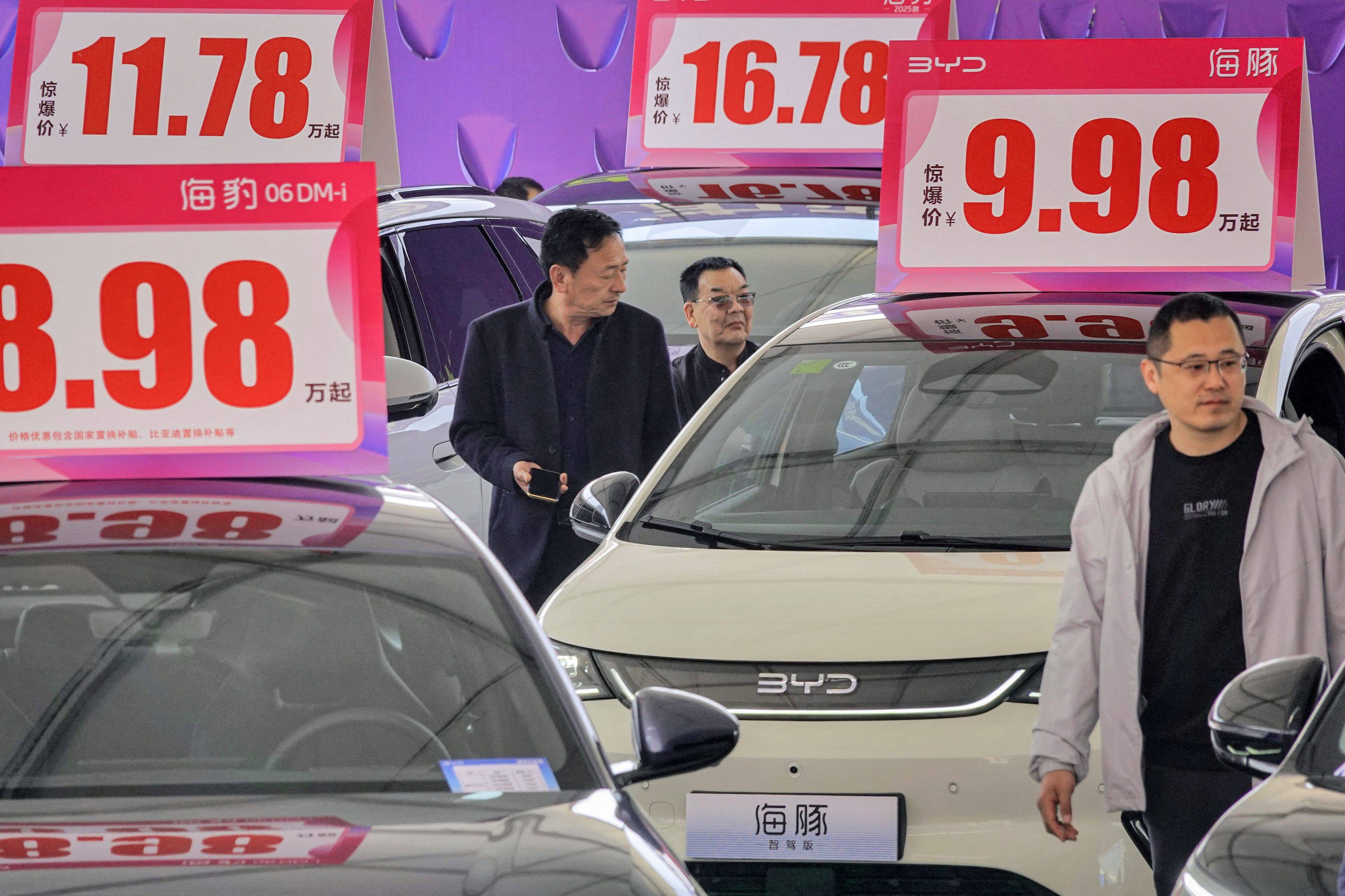 Customers look at BYD electric cars at an auto show in Yantai, in eastern China’s Shandong province, on April 10, 2025. Photo: AFP