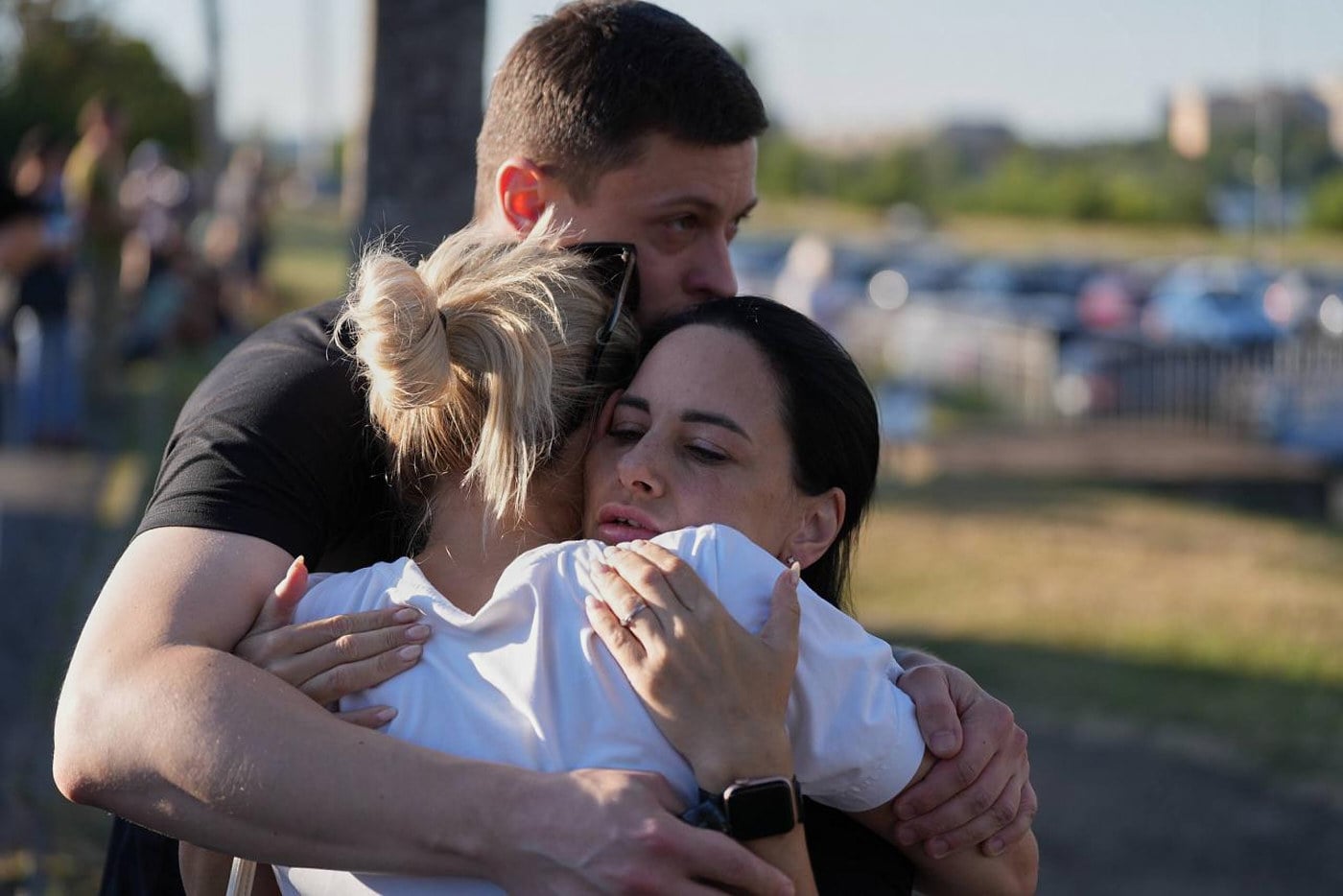 People embrace near a burning shopping centre following a Russian drone attack in Kryvyi Rih, Ukraine, on Friday. Photo: AP