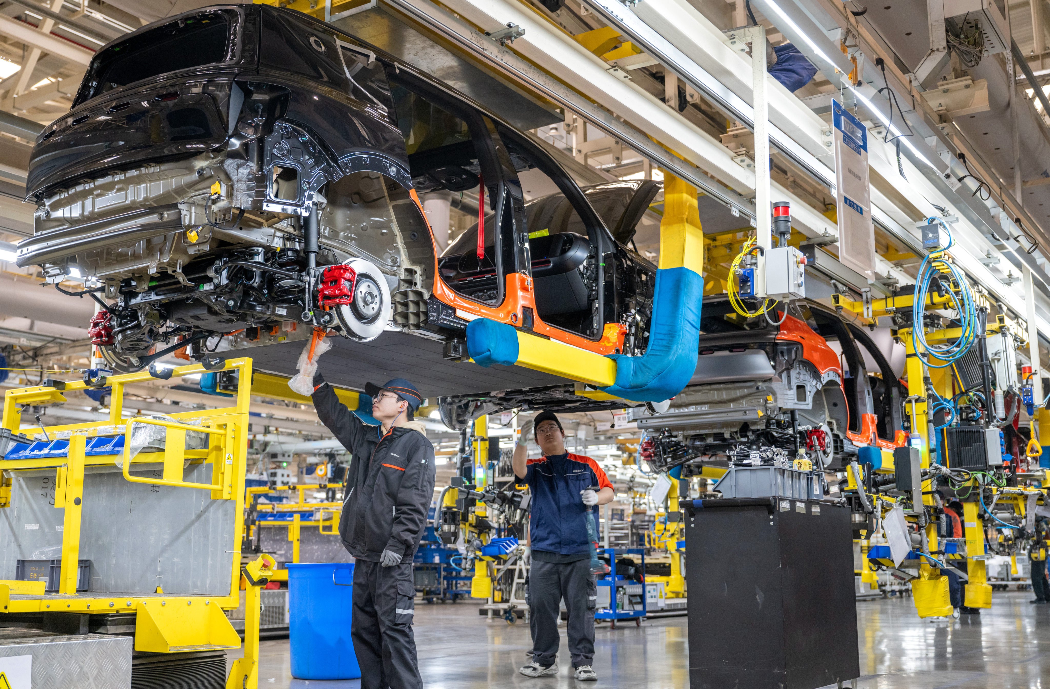 Technicians work at a Geely Auto plant in Zhejiang province. Photo: Getty Images
