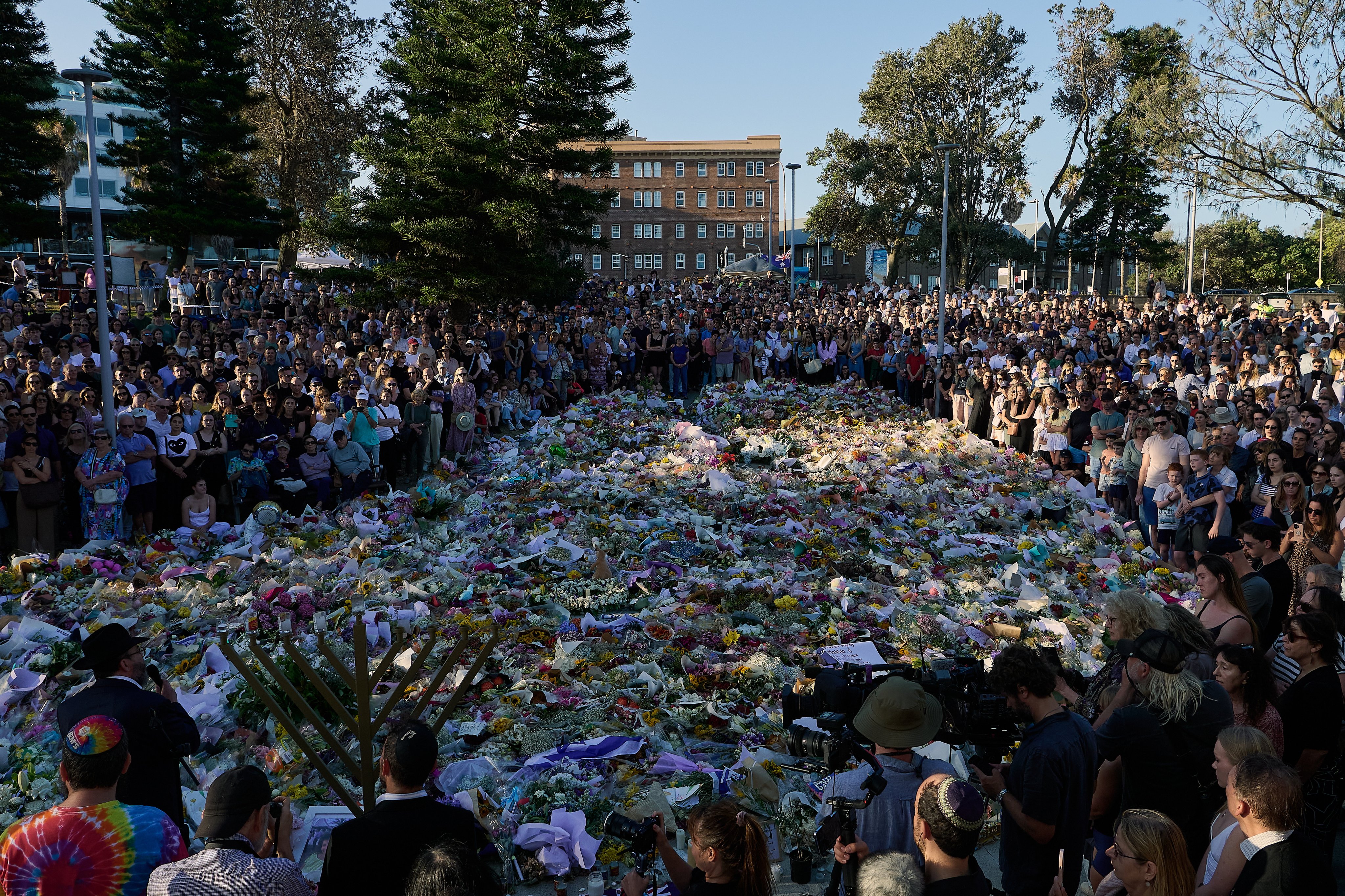 A crowd gathers in front of the flower tribute for the victims of the shooting at Bondi Beach, in Sydney, Australia, on December 17 last year. Photo: EPA