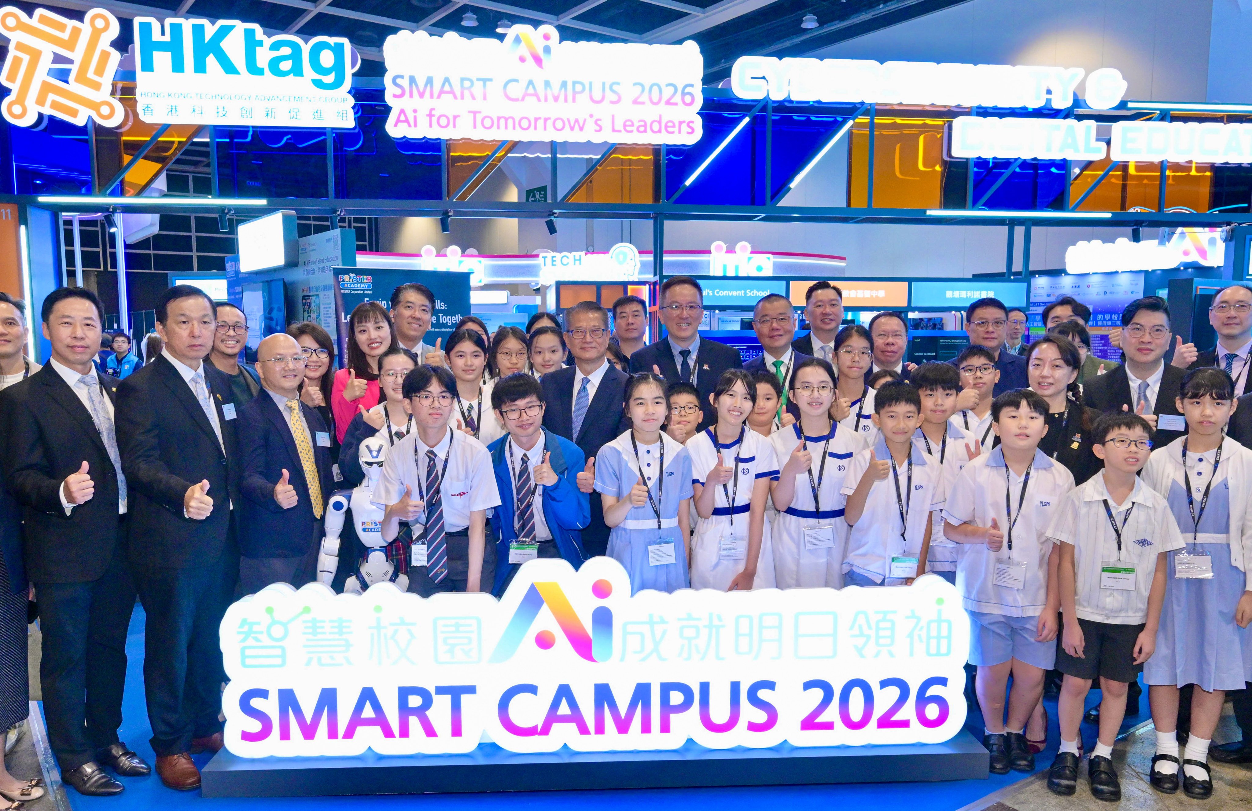 Finance chief Paul Chan poses for a group photo with officials and students at the festival. Photo: Handout