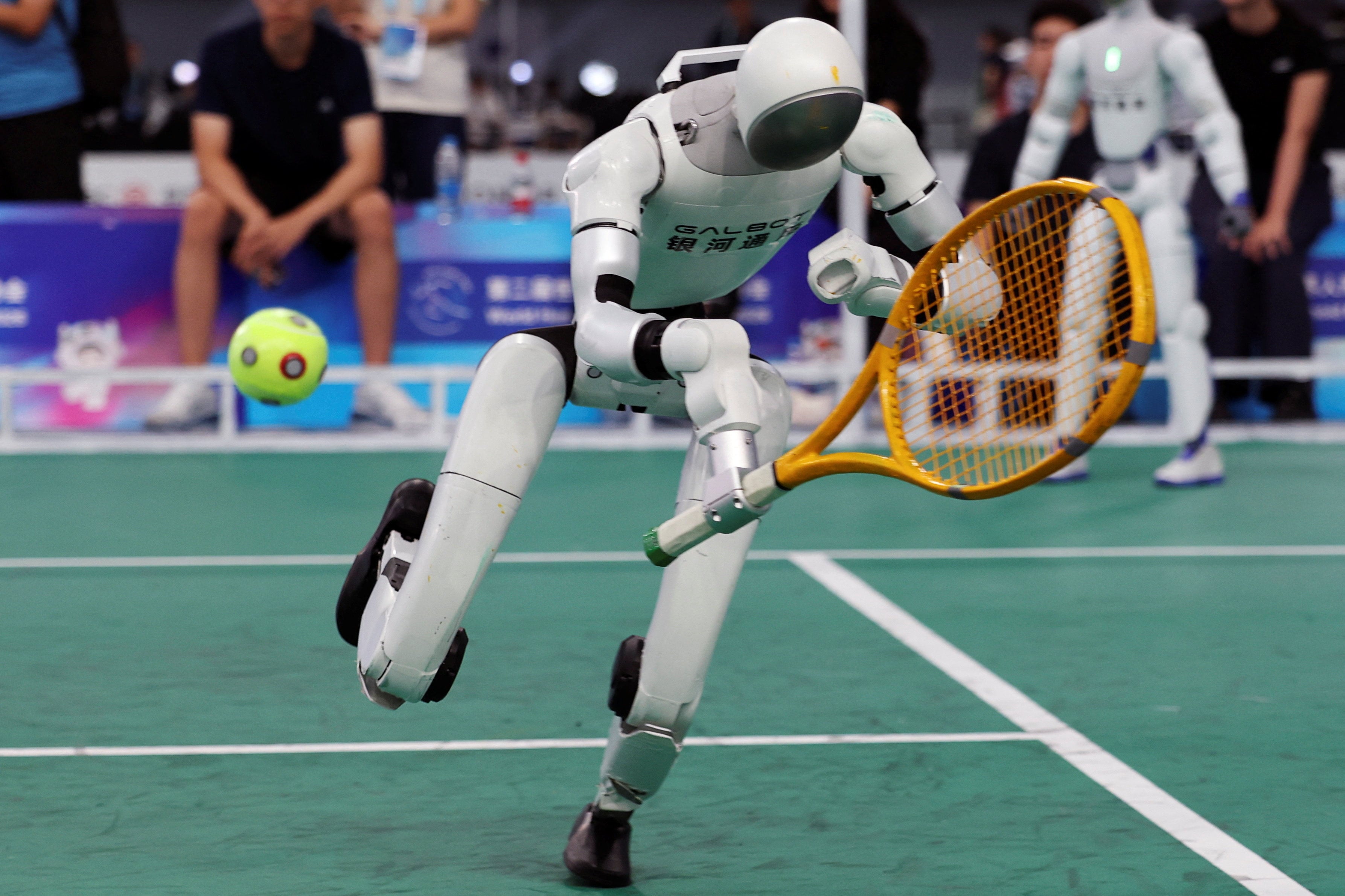 scmp.com - Howard Liu - Chinese robots tackle tennis, smash race records at World Humanoid Robot Games