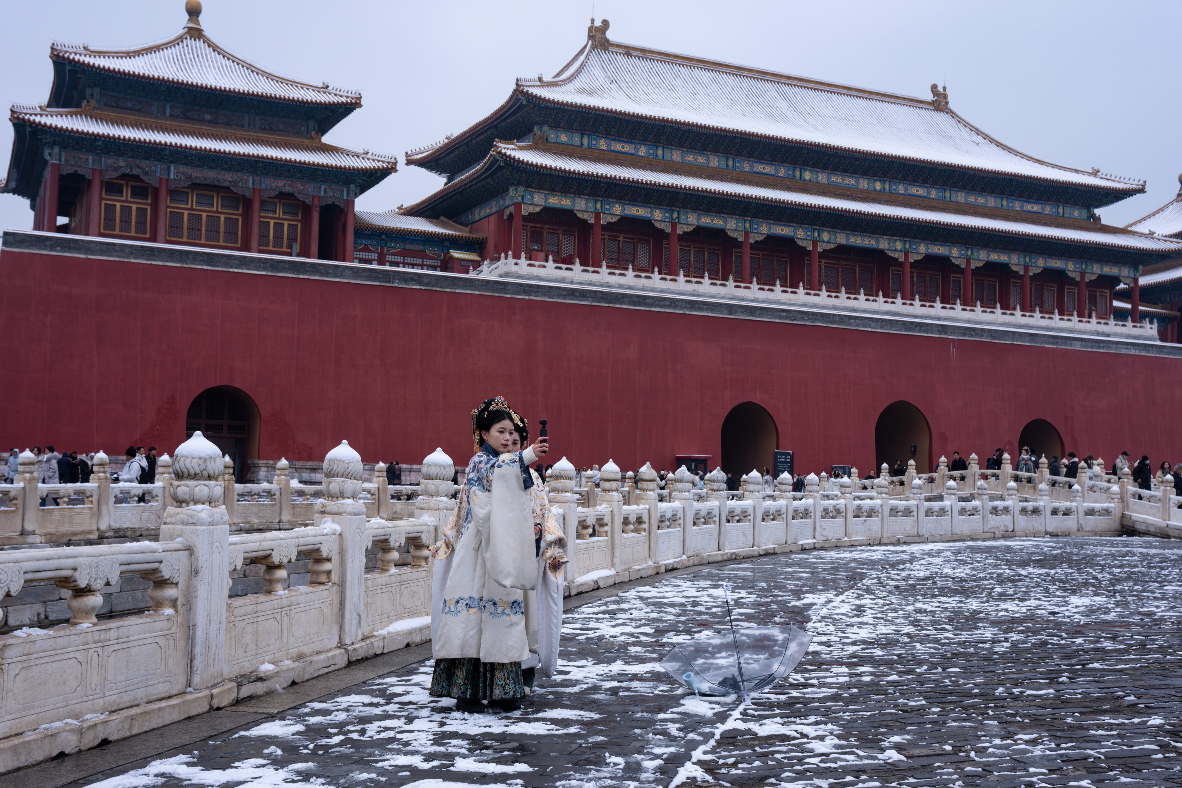 Women dressed in traditional costumes brave  sub-zero temperatures during a visit to Beijing’s Forbidden City on March 5. Photo: Robert Ng