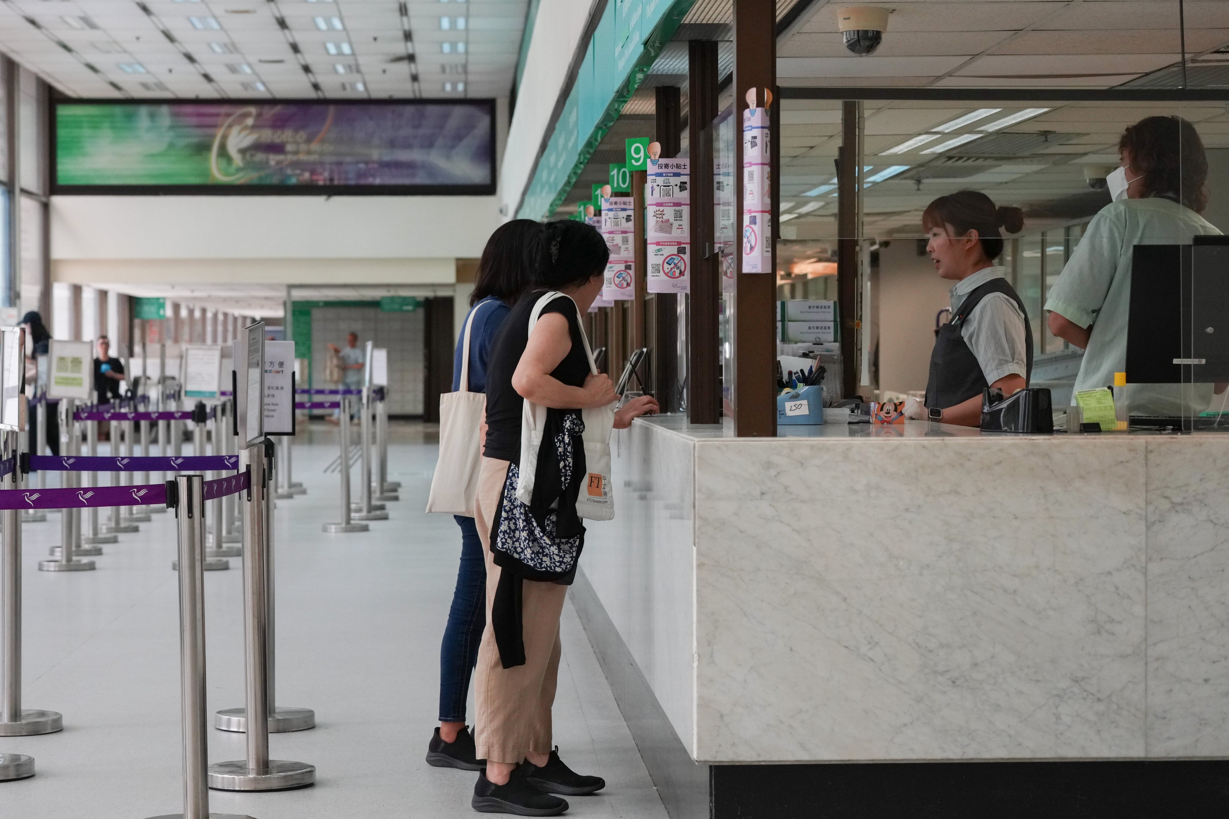 Customers at the General Post Office in Central, Hong Kong, on August 18. Facing operational challenges and declining mail volumes, Hongkong Post has announced that it will offer two-year contracts rather than permanent employment to those completing their probation this September. Photo: Jelly Tse