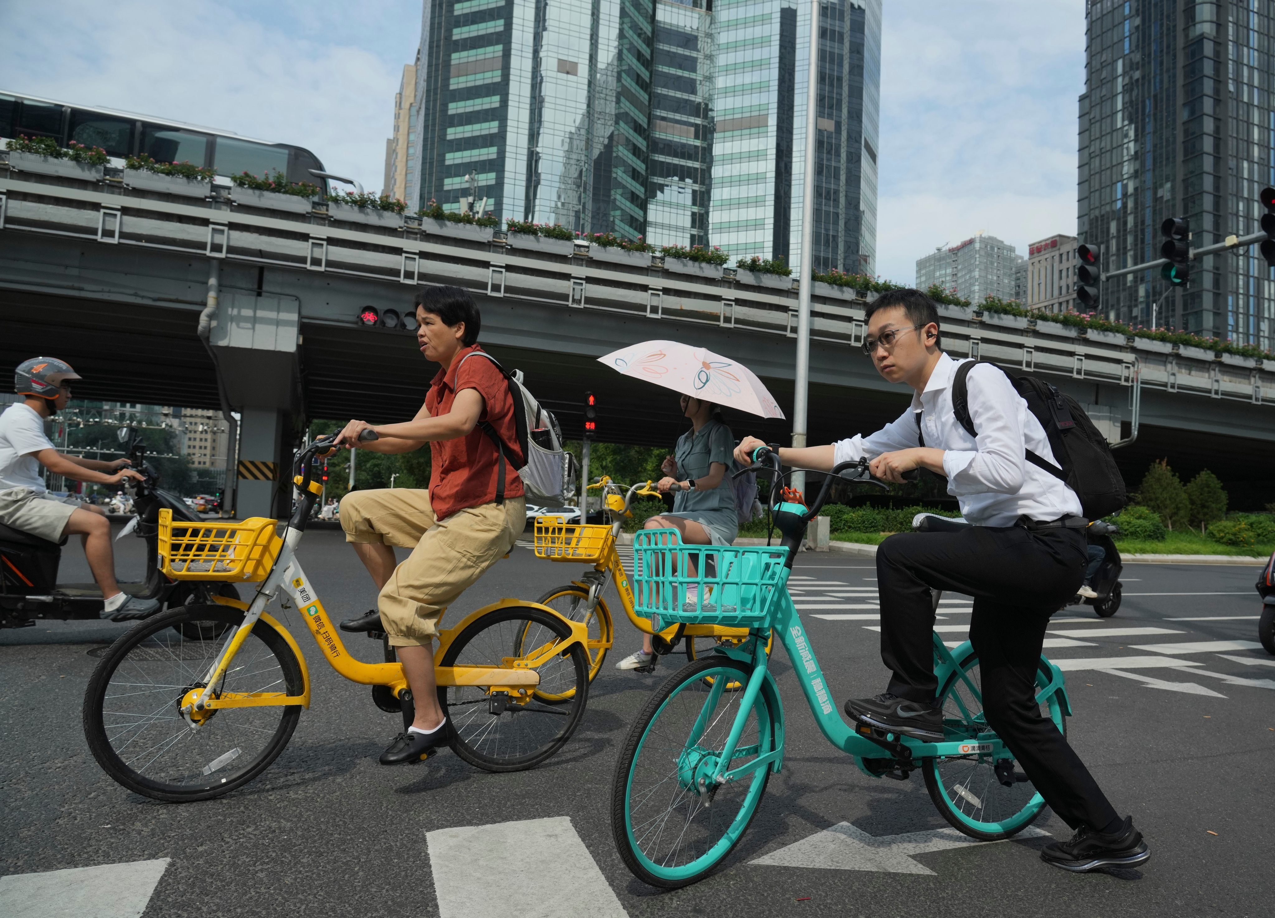 People ride bicycles on a street in Beijing. China’s leadership is looking to avoid an overreliance on strong policy stimulus while striving to reach economic growth goals. Photo: AP