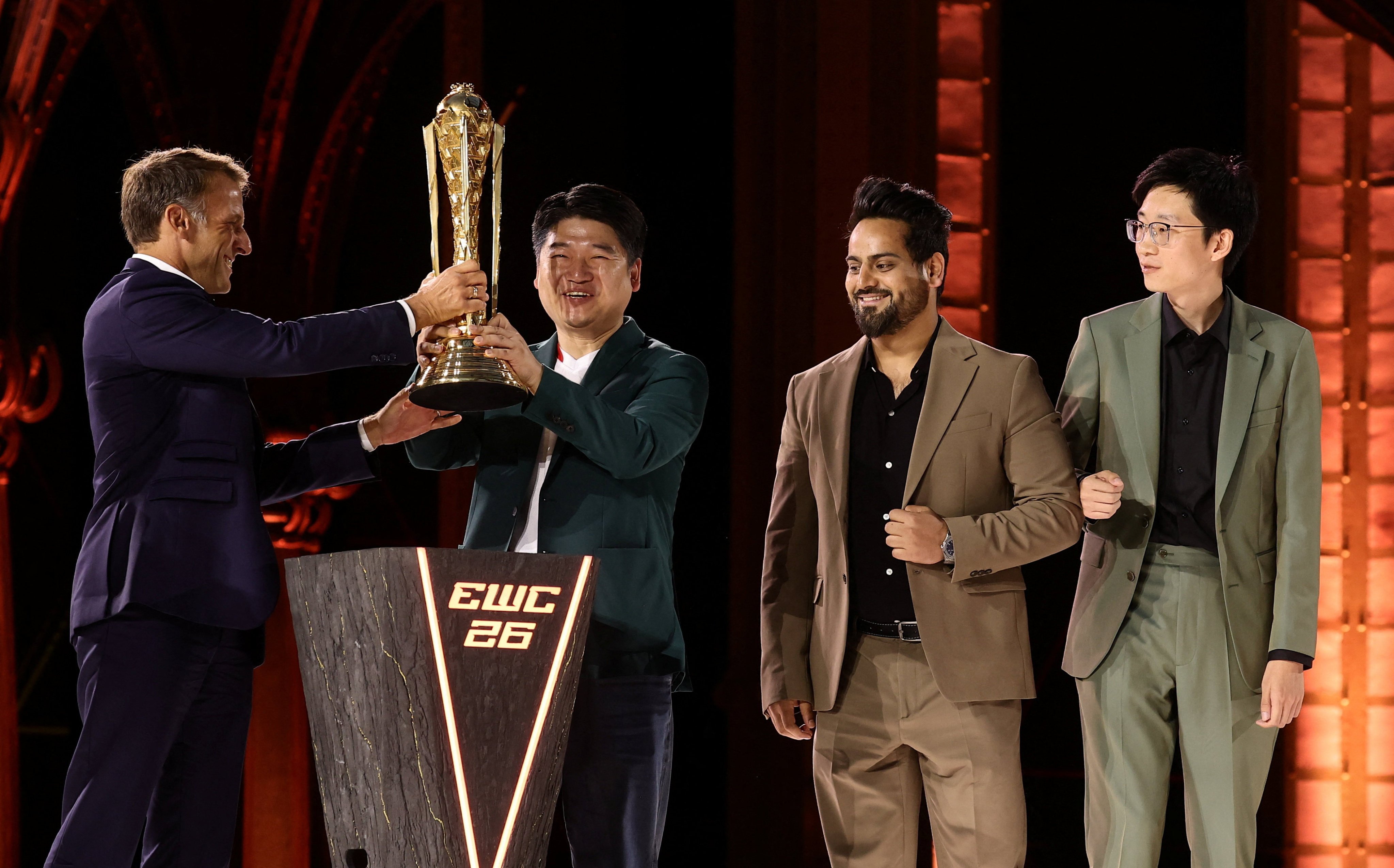 French President Emmanuel Macron presents the EWC 2026 Club champions award to Chinese club AG.AL at the closing ceremony of the Esports World Cup at the Grand Palais in Paris on Sunday. Photo: Reuters