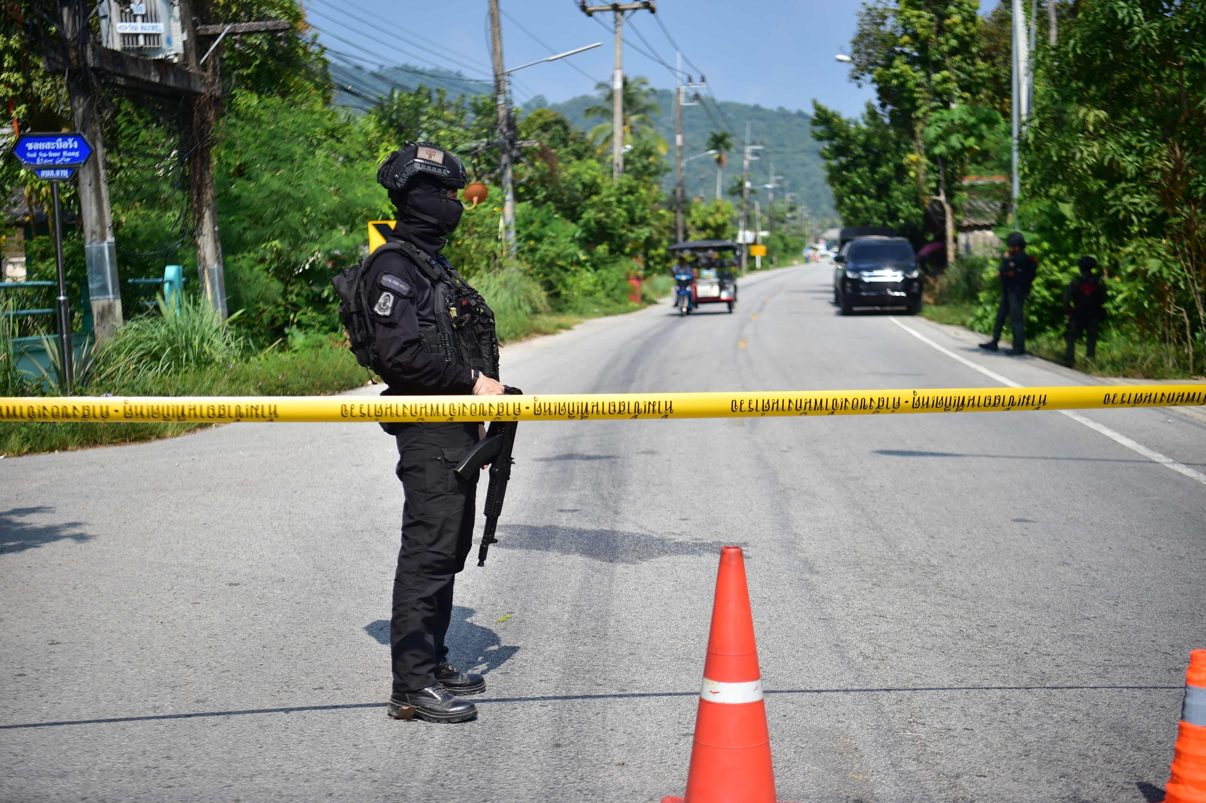 Thai soldiers stand guard at checkpoint in the southern province of Narathiwat on Sunday after the wave of attacks. Photo: AFP