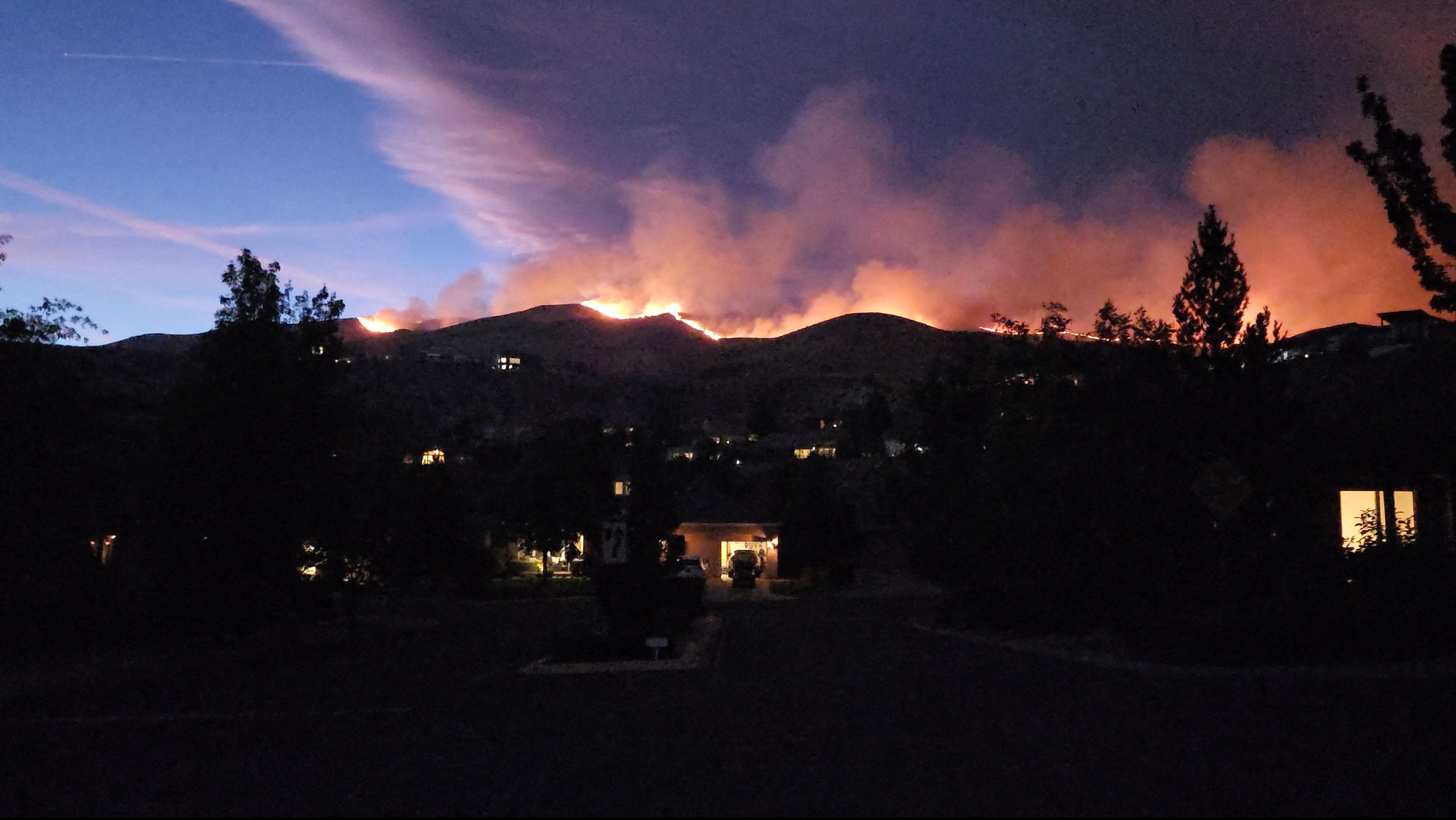 Smoke and flames rise from the Hawk fire in Reno, Nevada, US at the weekend in a screen grab from a social media video. Photo: @SquintDev / via Reuters