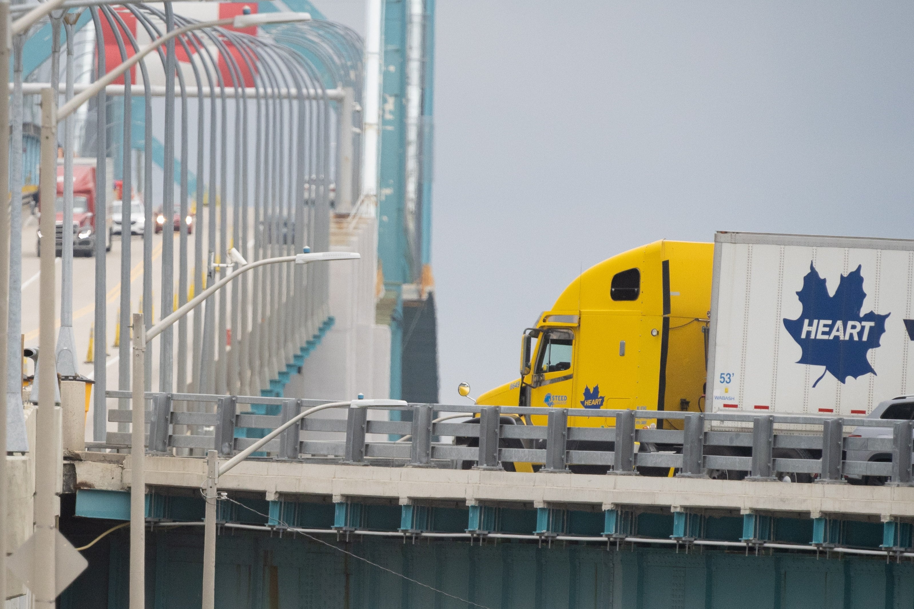 Transport trucks cross the Ambassador Bridge into the United States, in Windsor, Ontario, Canada, on Saturday. Photo: The Canadian Press via AP