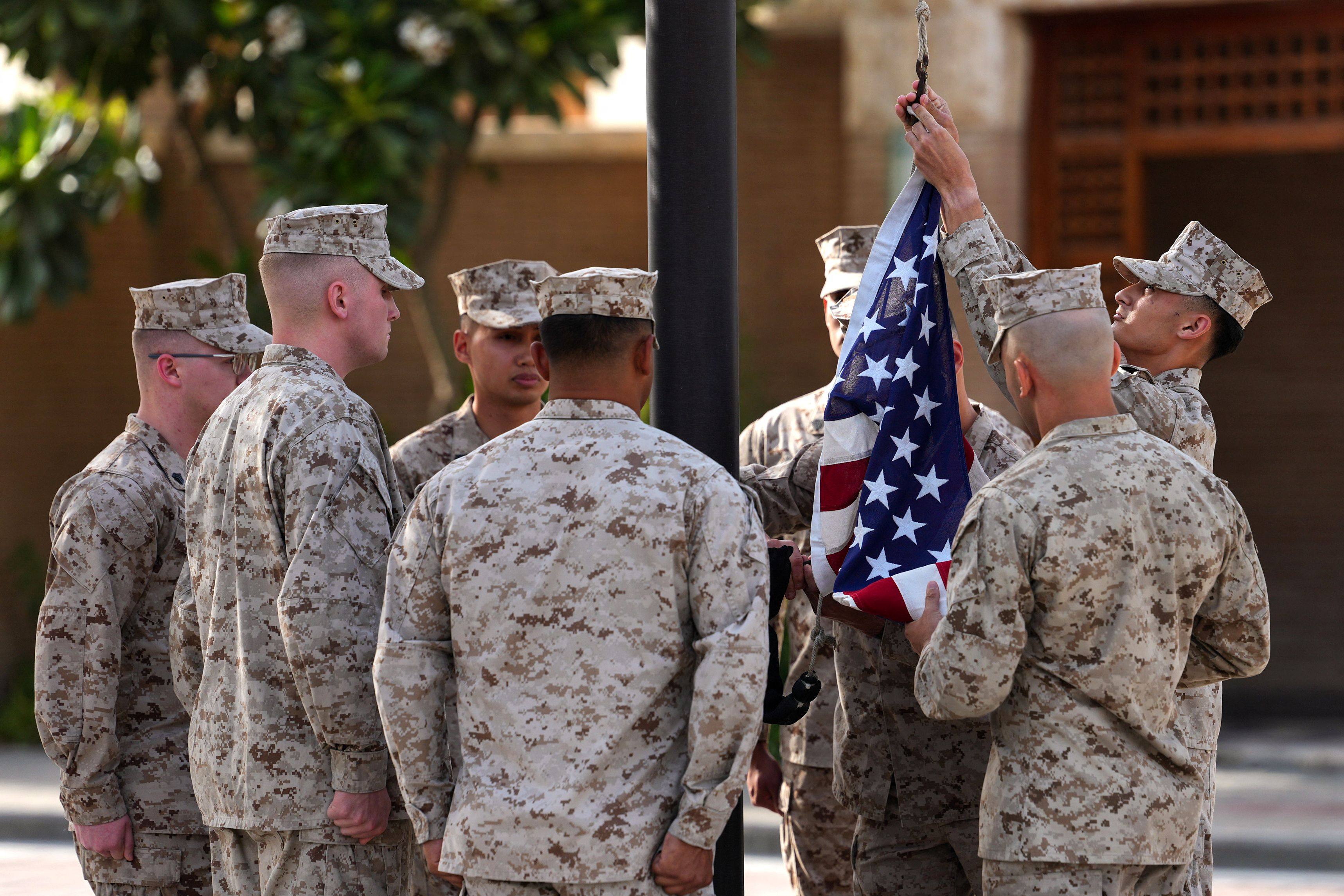 US Marines raise the flag at the US embassy in Kuwait during a ceremony on June 24. Photo: AFP