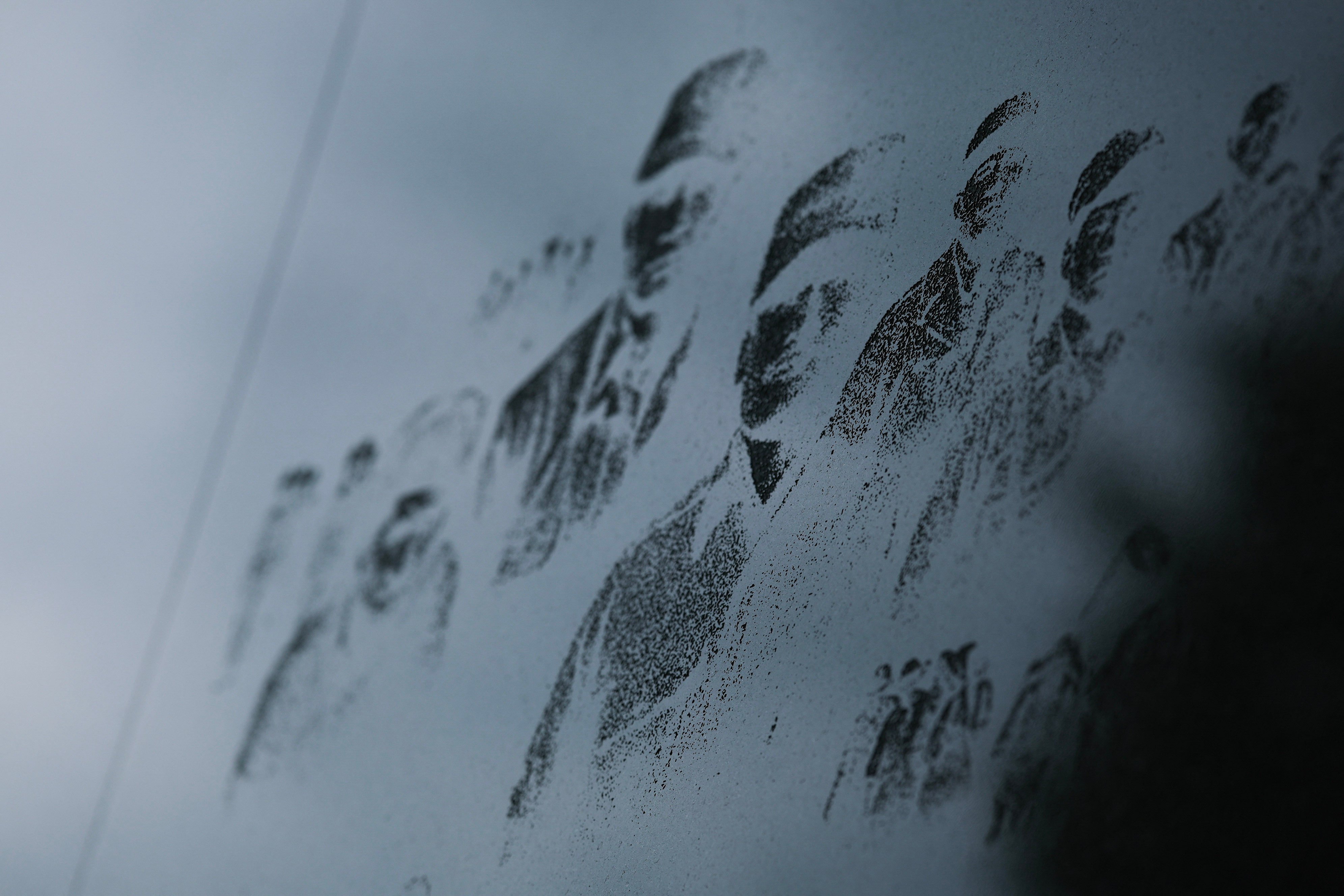 Faces of Korean War Service Members are seen on the mural wall of the Korean War Memorial in Washington on August 18. Photo: Getty Images/AFP