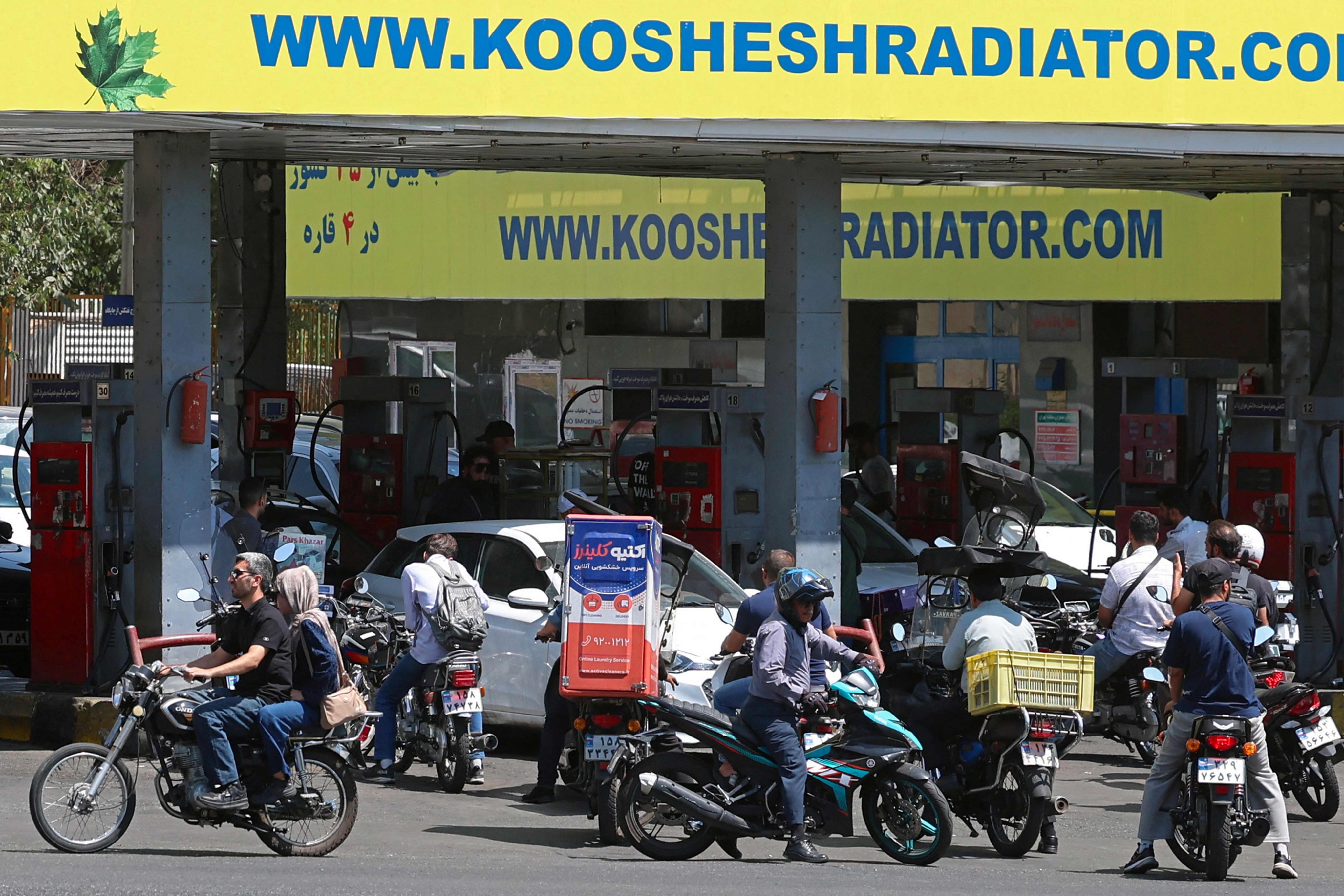 Drivers queue at a petrol station to refuel in Tehran, Iran, on Tuesday. Photo: AFP