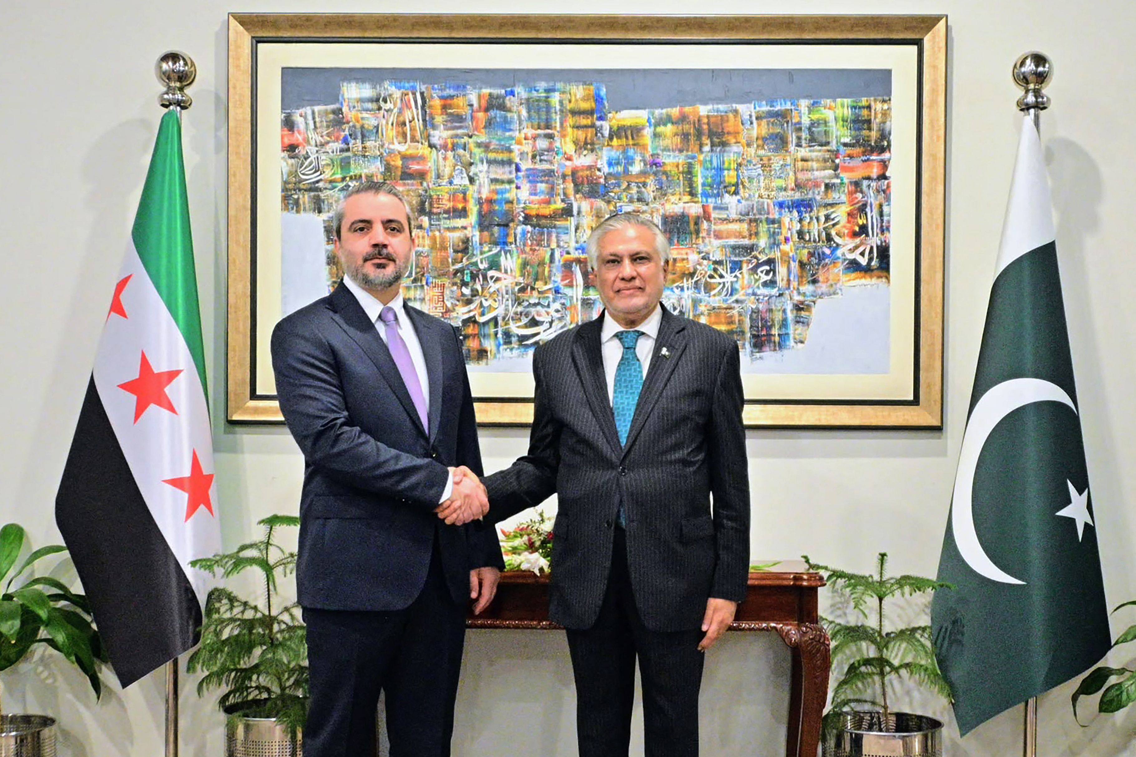 Syrian Foreign Minister Asaad al-Shaibani (left) shakes hands with his Pakistani counterpart Ishaq Dar in Islamabad on Thursday. Photo: Ministry of Foreign Affairs of Pakistan / AFP