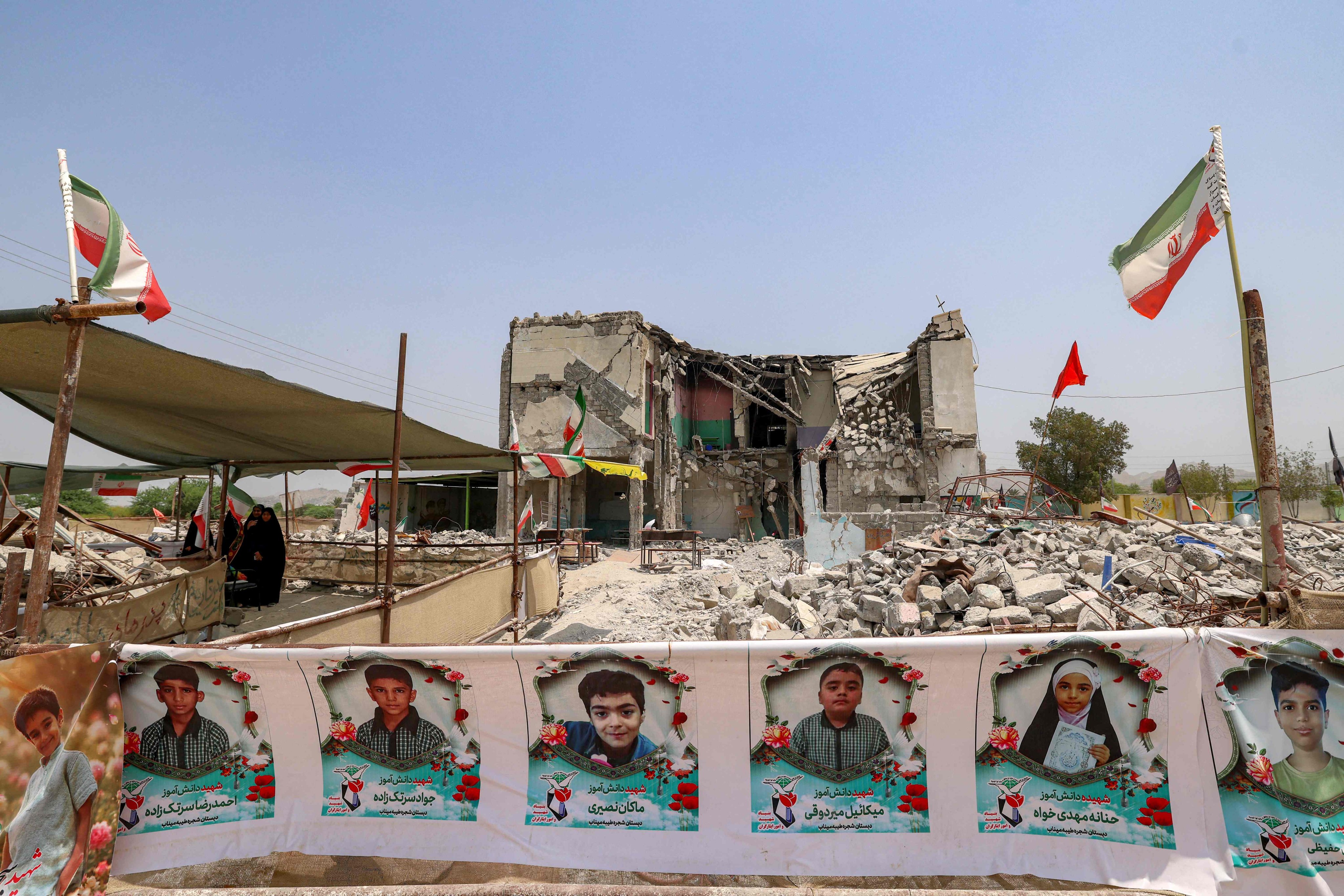 Rubble and portraits of children line the site of the destroyed Shajareh Tayebeh school in Minab, Iran. Photo: AFP