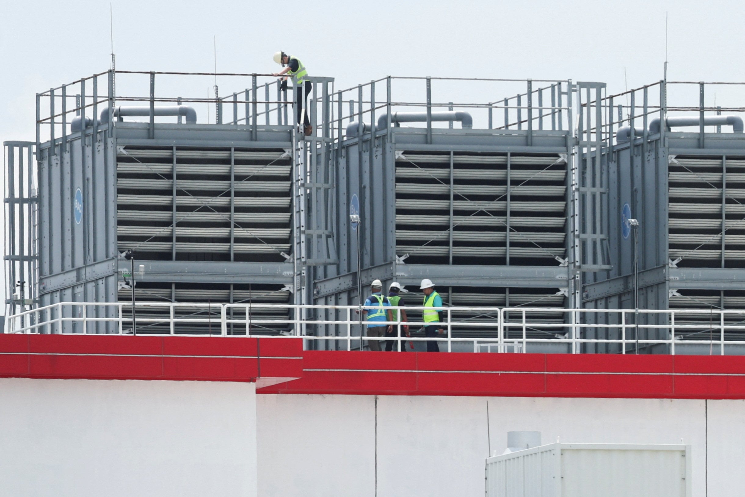 Workers inspect cooling equipment at a data centre in Malaysia’s Johor state in May. Photo: Reuters