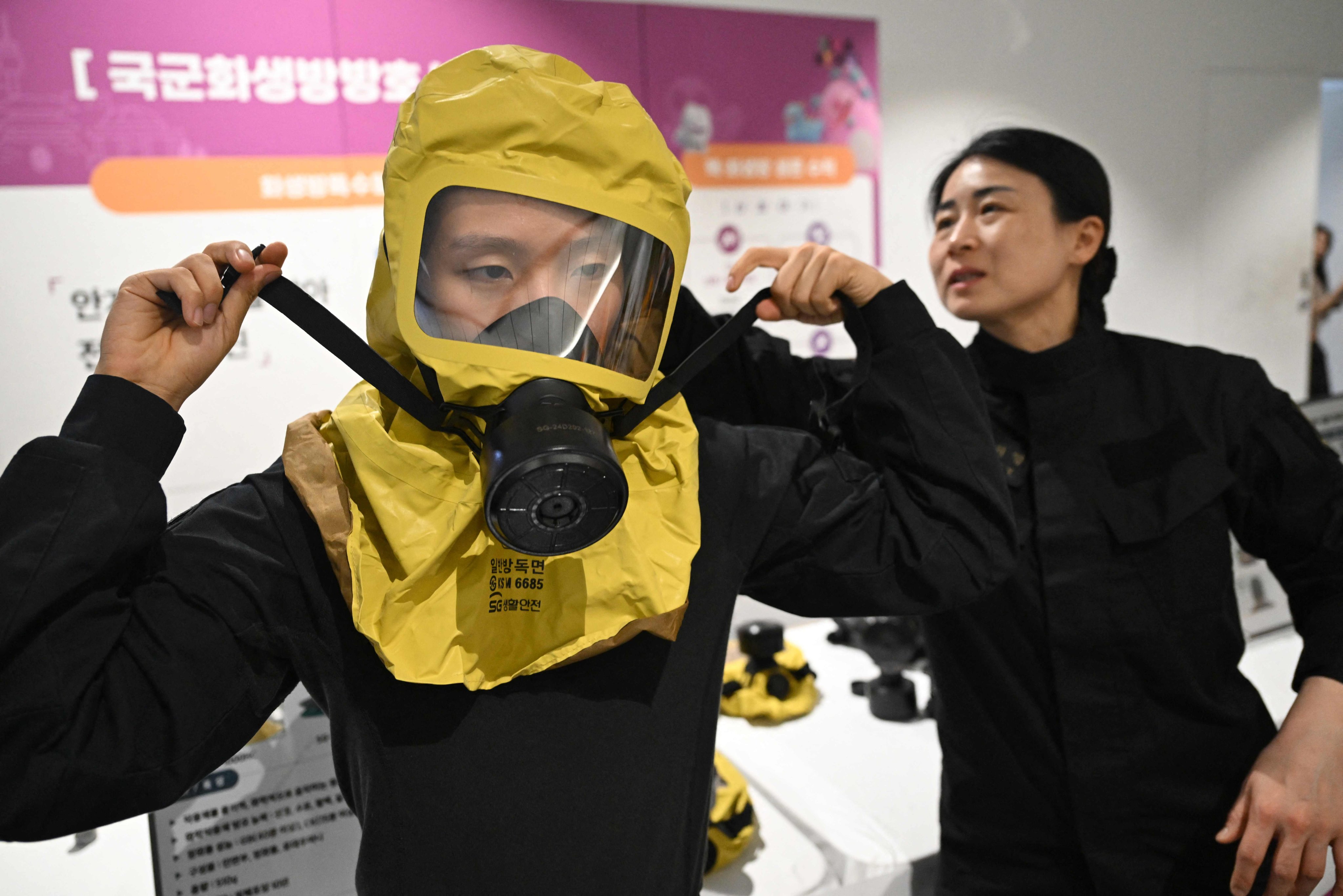 A South Korean soldier demonstrates wearing a gas mask during a civil defence drill against possible artillery attacks by North Korea at a shelter in Seoul on Thursday. Photo: AFP