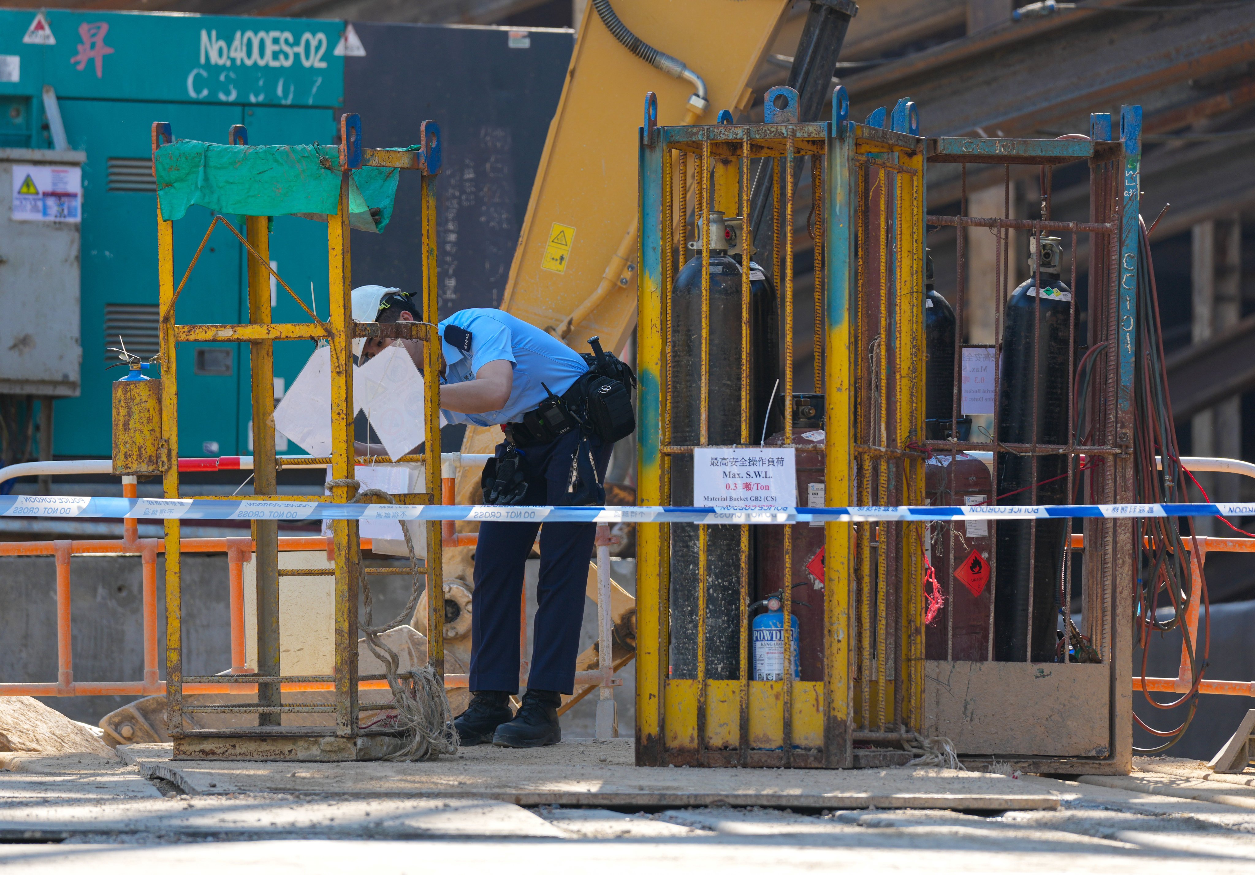 Police officers investigate at a construction site in Tsuen Wan after three gas cylinders fell from a crane, killing one worker and injuring two others in January. Photo: Jelly Tse