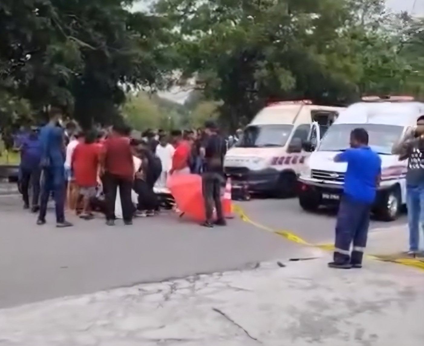 Paramedics attend to the victim after a brawl in Shah Alam, Malaysia’s Selangor state, on Tuesday in this still from a social media video. Photo: Threads