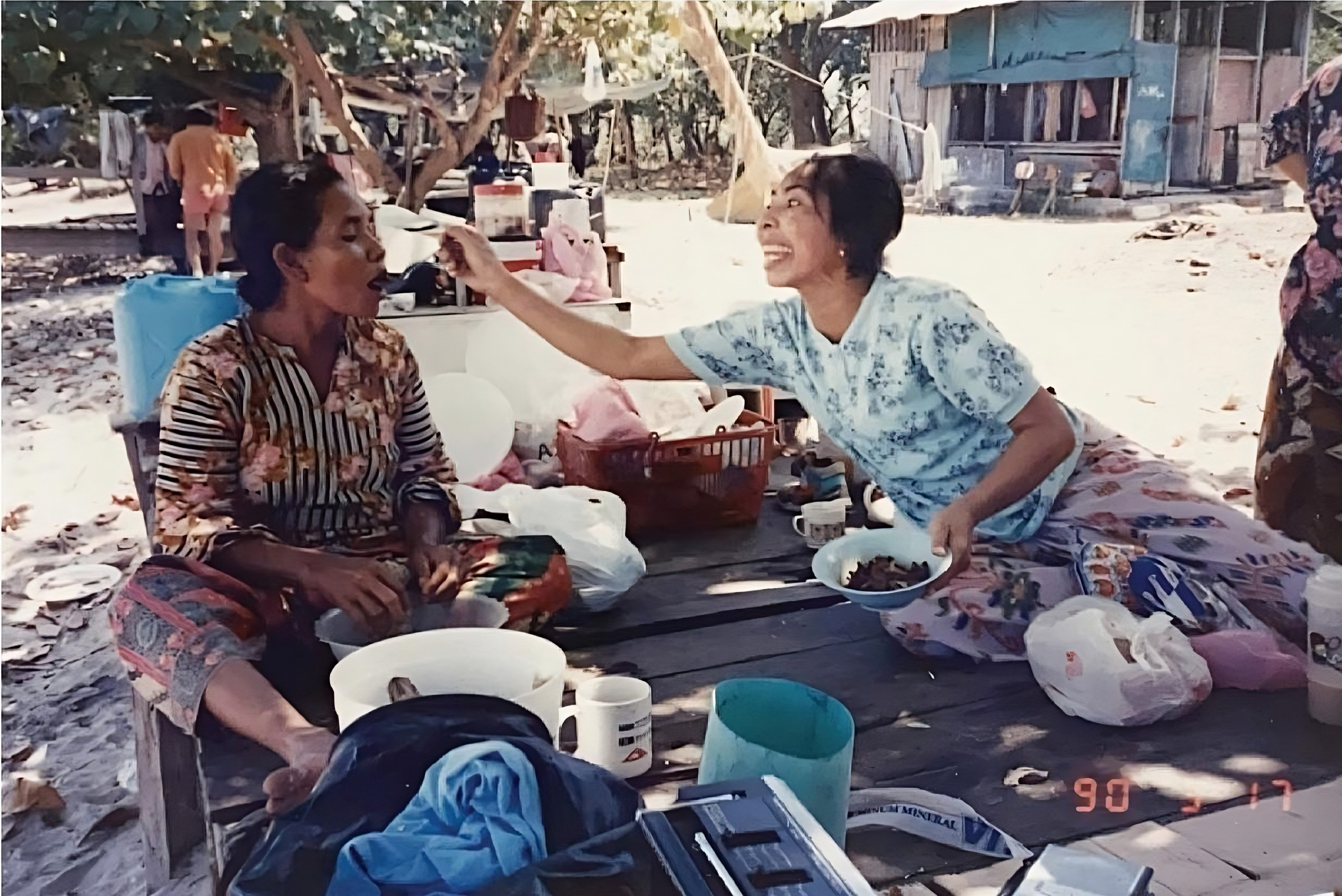 A photograph taken in 1990 shows two matriarchs enjoying food on the beach at Pulau Semakau. Photo: Instagram/ oranglautsg