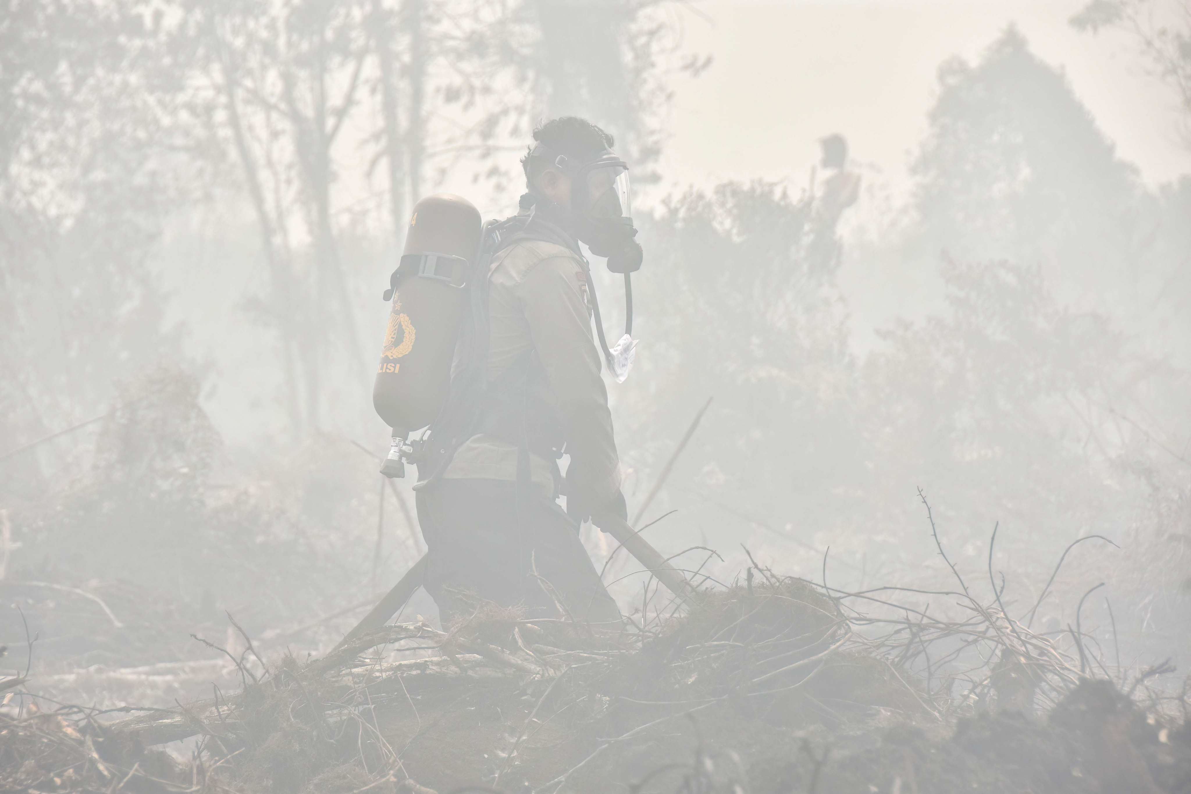 Firefighters extinguish a peatland fire at Tambang in Indonesia’s Riau province on Tuesday. Photo: Wahyudi/AFP