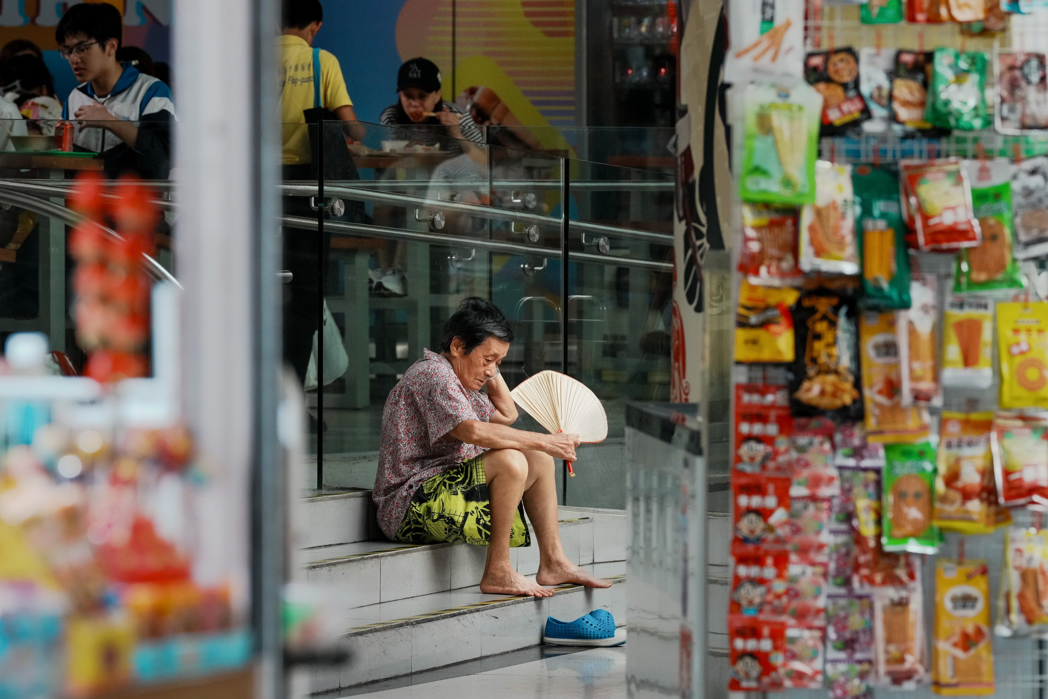 An elderly woman takes shelter from the heat at a shopping centre in Sham Shui Po. Older residents are increasingly vulnerable to Hong Kong’s extreme temperatures during the summer months. Photo: Dickson Lee