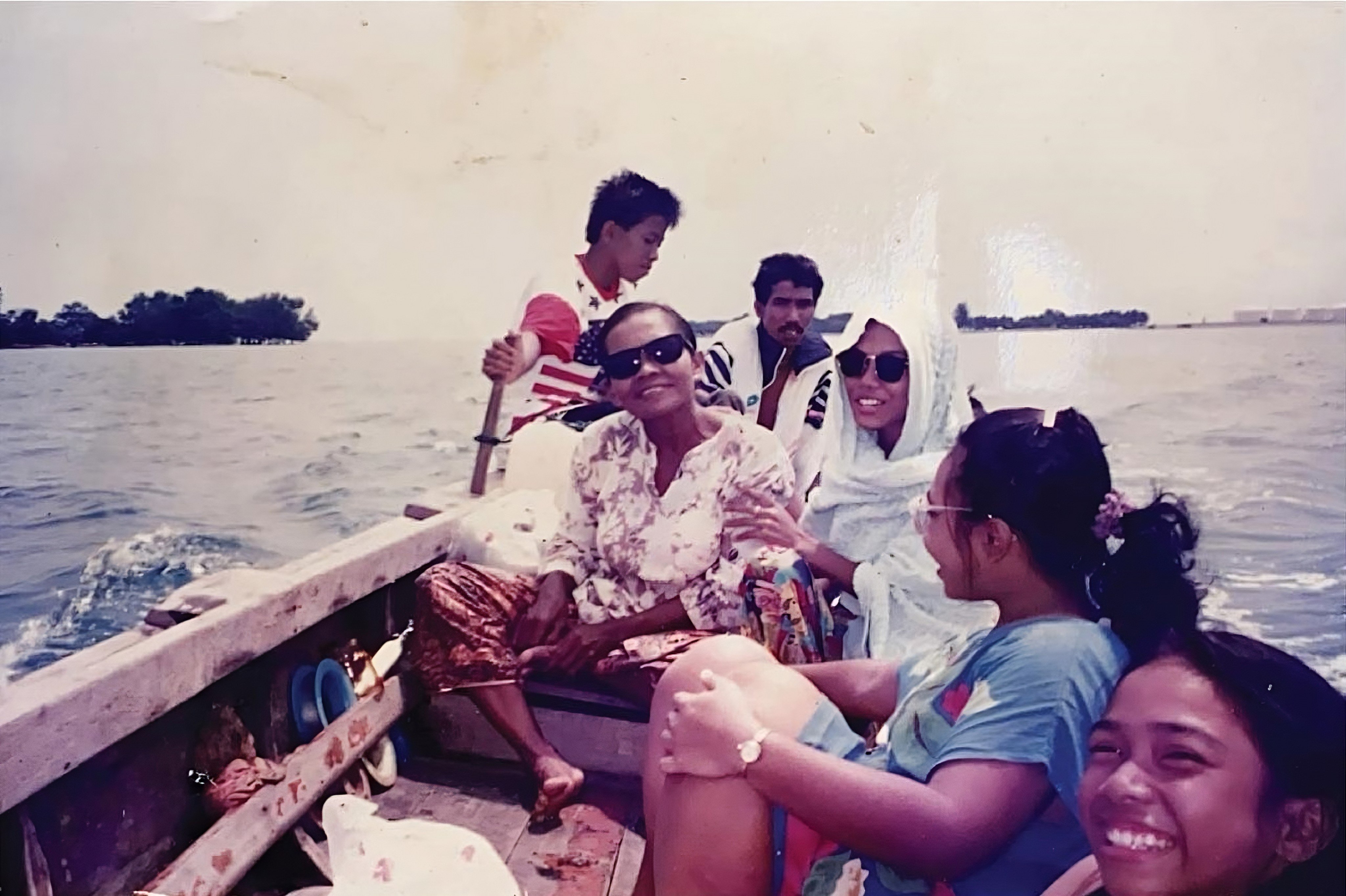 An old photo shows a family’s boat trip to Pulau Seking to get supplies while revisiting Pulau Semakau in 1988 after relocating to mainland Singapore. Photo: Instagram/oranglautsg