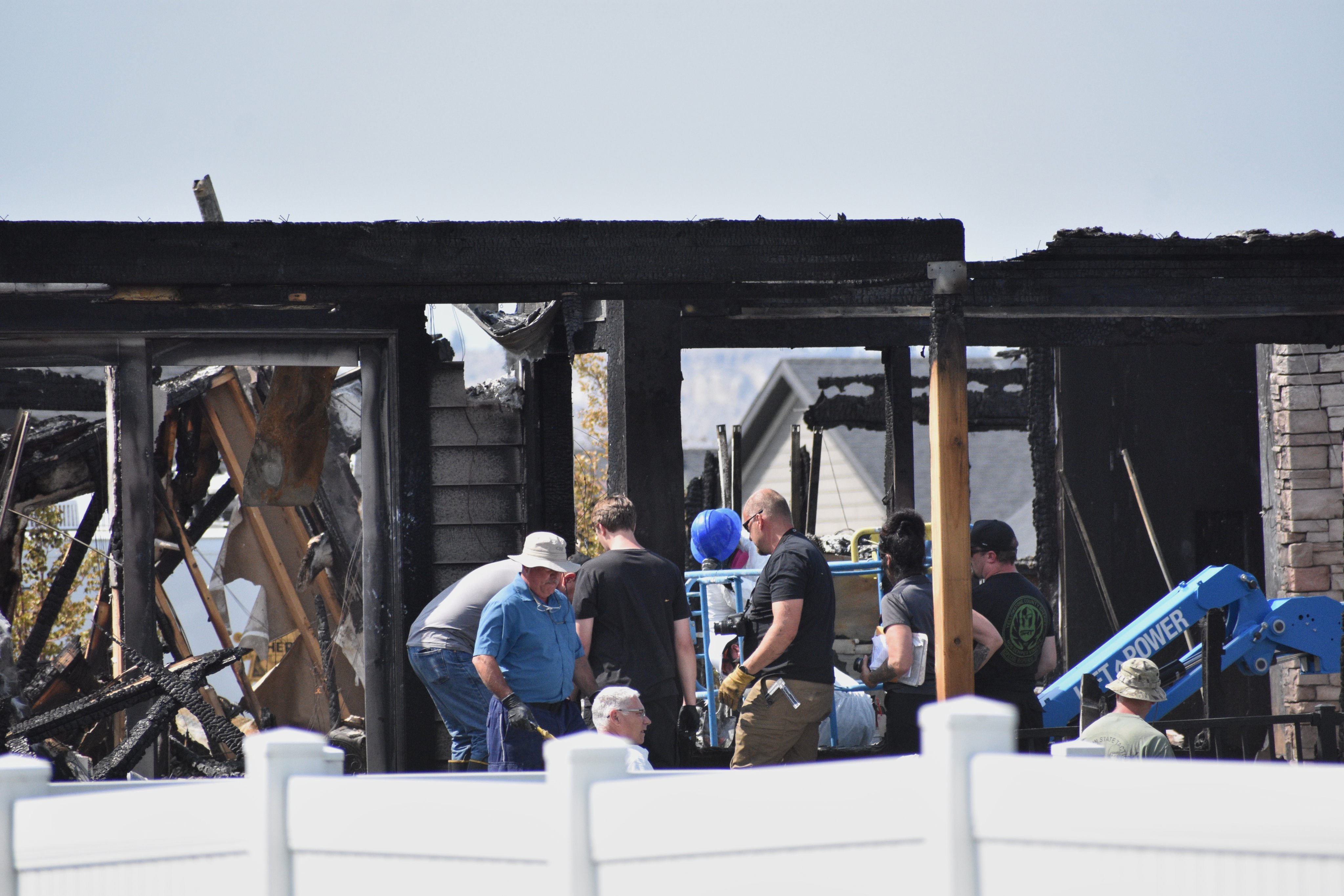 Investigators at the scene on Tuesday where a family was killed and the house burned, in Billings, Montana. Photo: AP