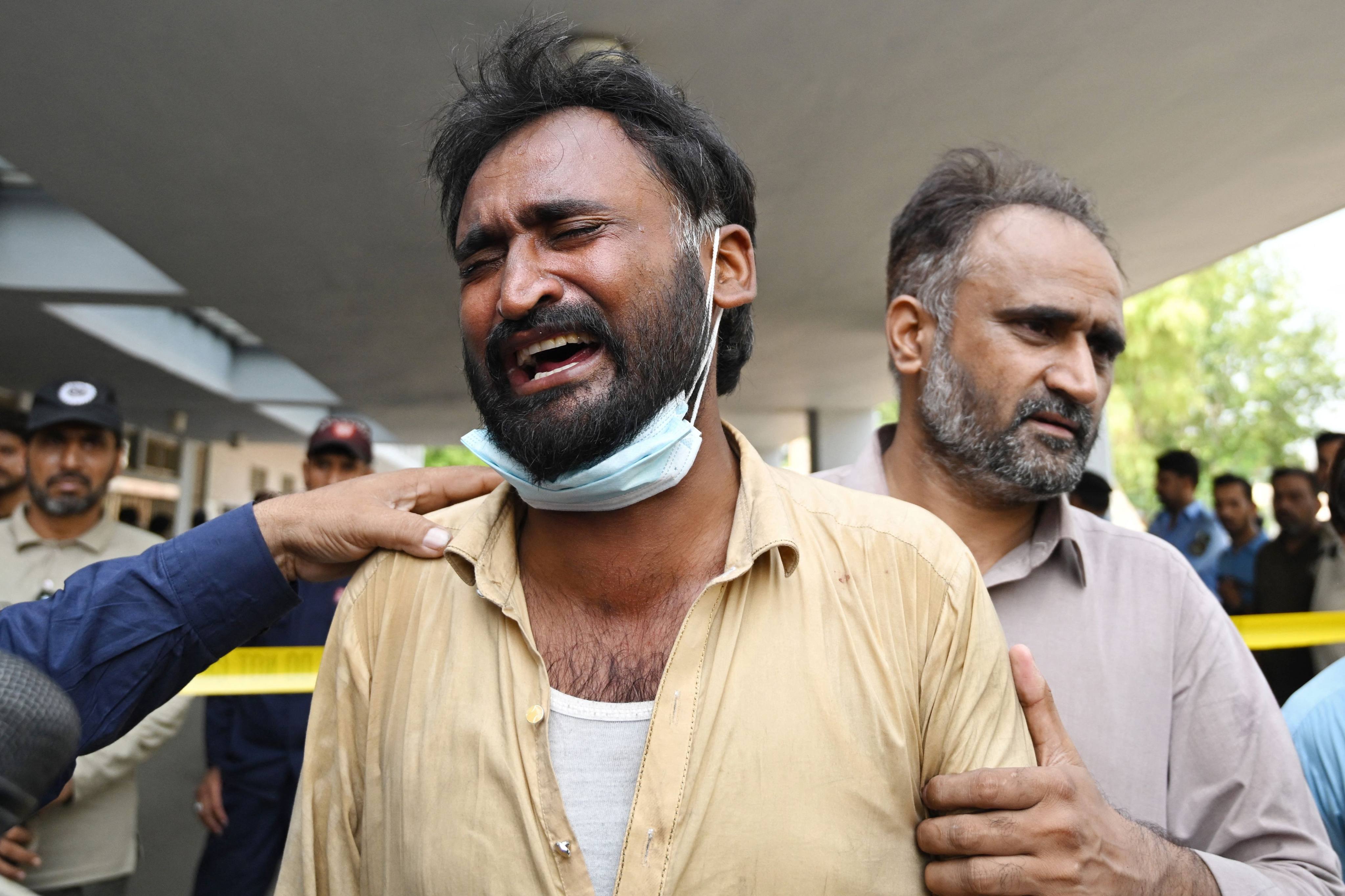 A father mourns his child following a fire at the Pakistan Institute of Medical Sciences' mother and child health ward on Wednesday. Photo: AFP