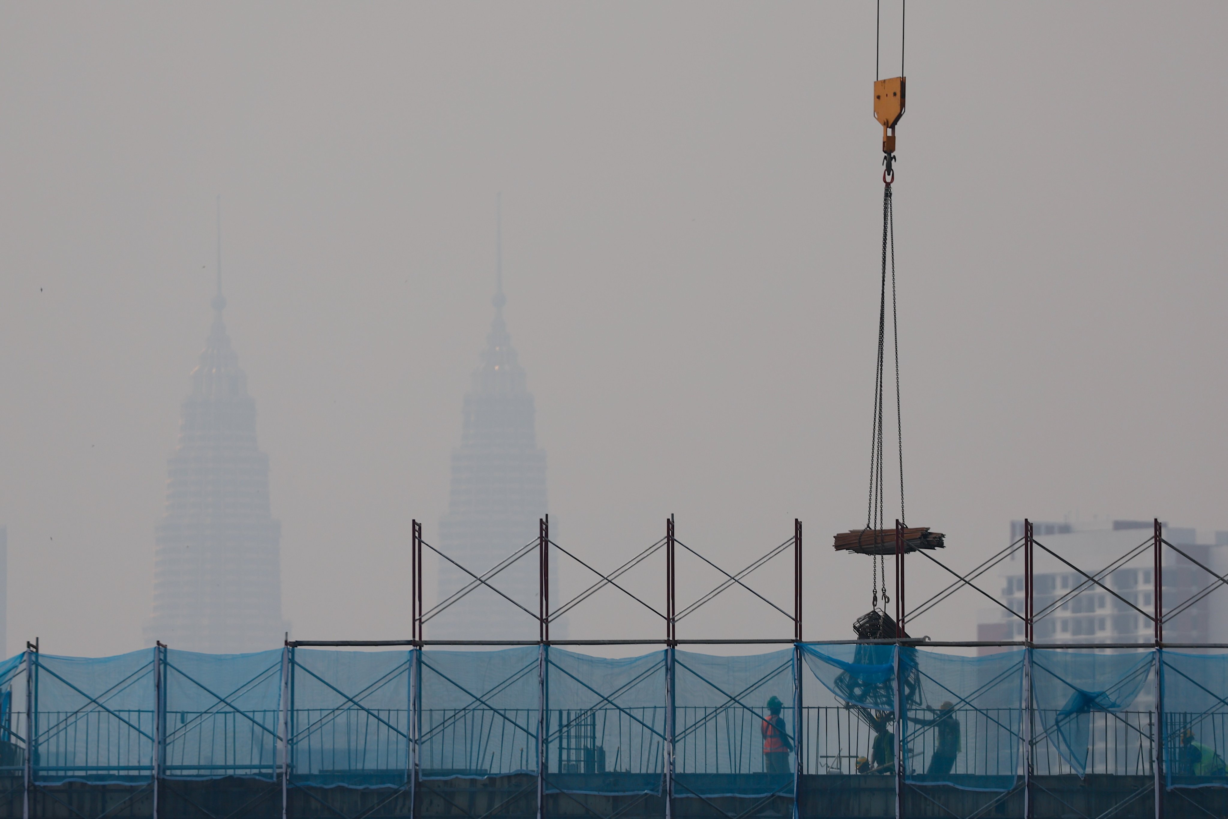 The Petronas Twin Towers are barely perceptible in the distance as haze shrouds Kuala Lumpur on August 13. Photo: EPA