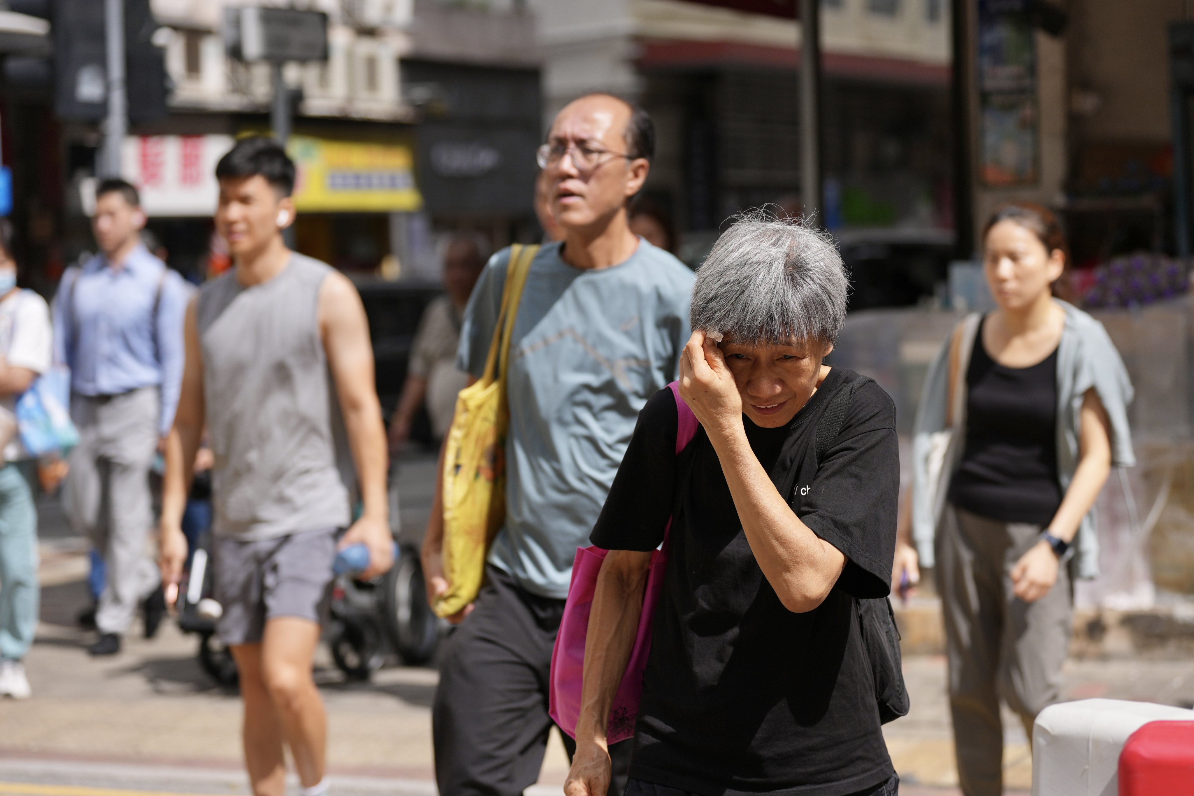 A woman struggles in the sweltering heat in Hong Kong amid record-high temperatures in August. Photo: Karma Lo